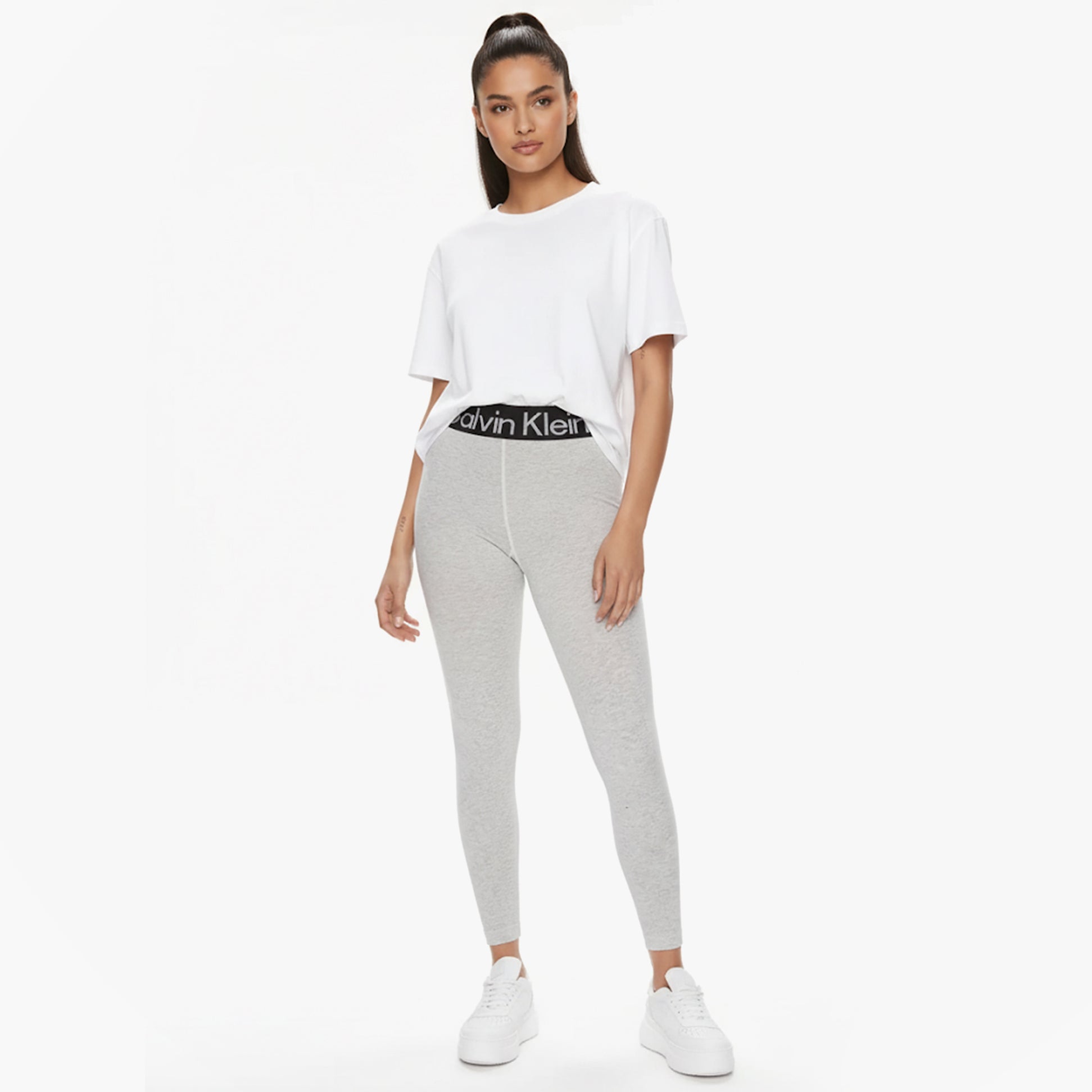 Calvin Klein LOGO Waist Leggings Grey front view model wearing leggings with CK logo waistband and white tee.
