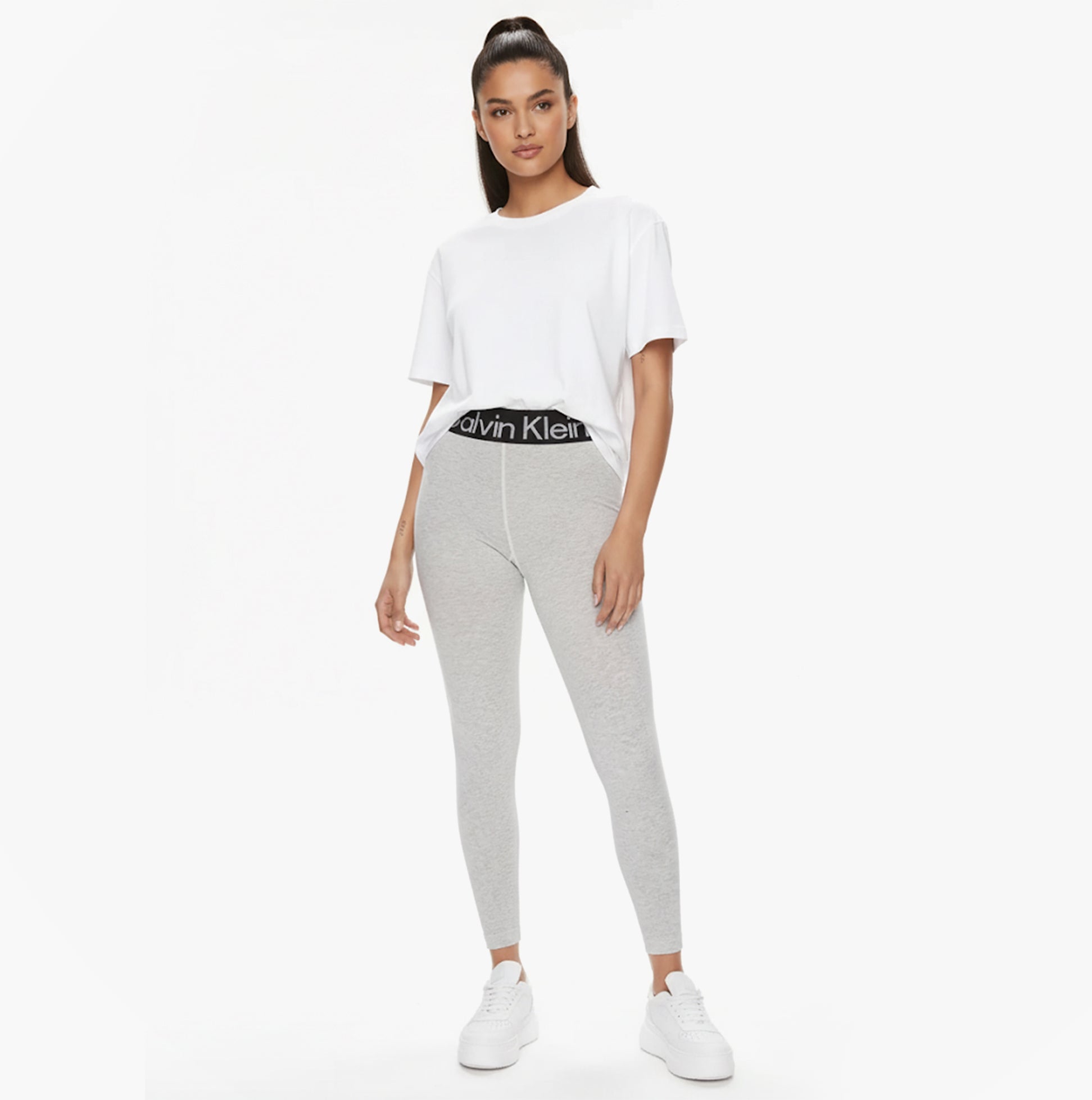 Calvin Klein LOGO Waist Leggings Grey front view model wearing leggings with CK logo waistband and white tee.