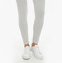 Calvin Klein LOGO Waist Leggings Grey front view with white sneakers, showcasing slim fit and comfort material.