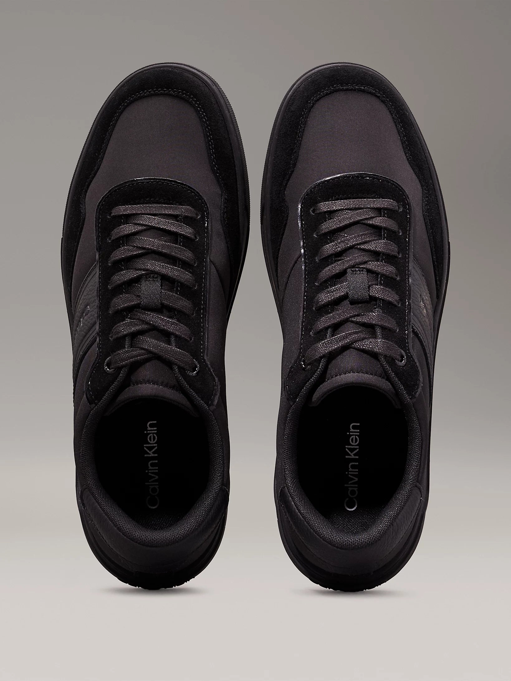 Calvin Klein LOW TOP LACE UP MIX Mens Trainers Triple Black top view with lace-up closure and round toe.