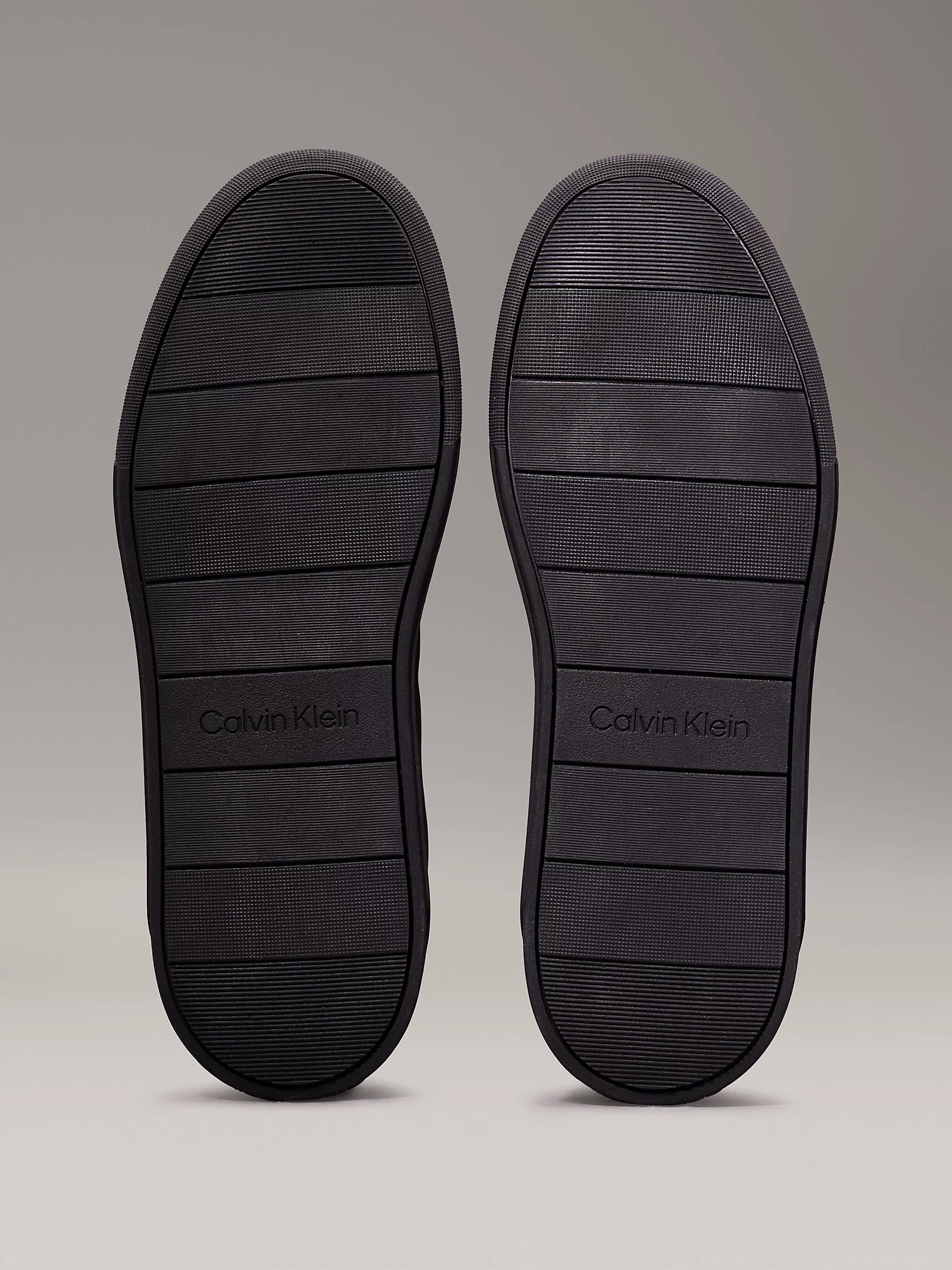 Calvin Klein LOW TOP LACE UP MIX Mens Trainers Triple Black sole view showcasing rubber materials and traction grooves.
