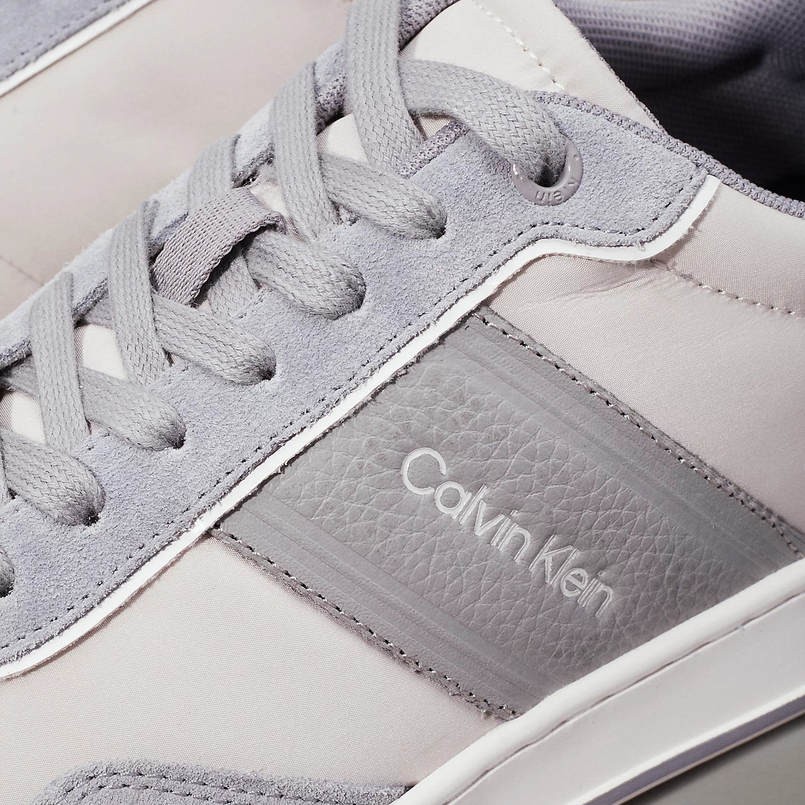 Calvin Klein LOW TOP LACE UP MIX Mens Trainers Light Grey/Granite Road detail view of shoe upper with laces and logo.