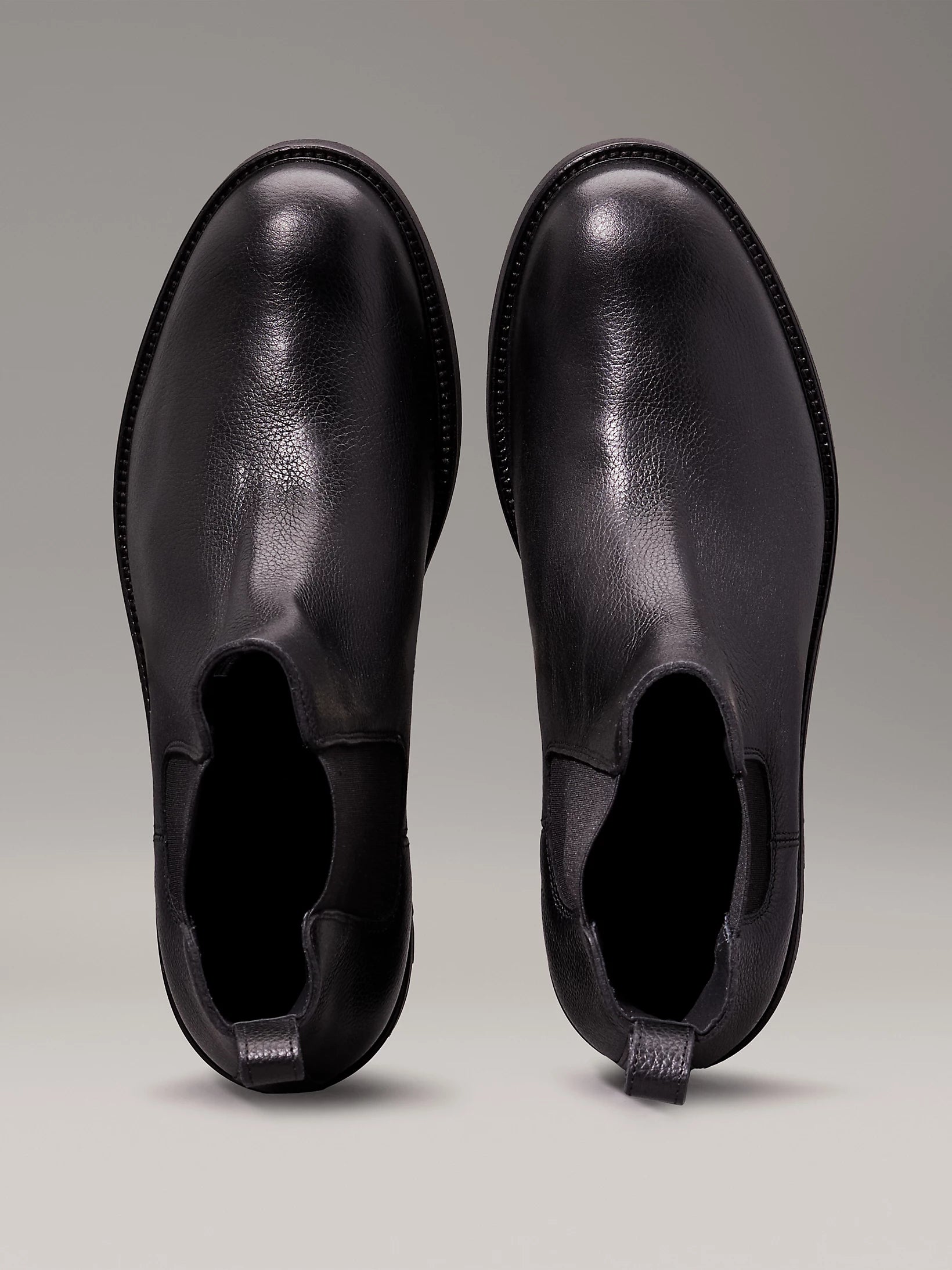 Calvin Klein CHELSEA BOOTS Mens Ck Black top view of leather ankle boots with round toe and elasticated side panels.