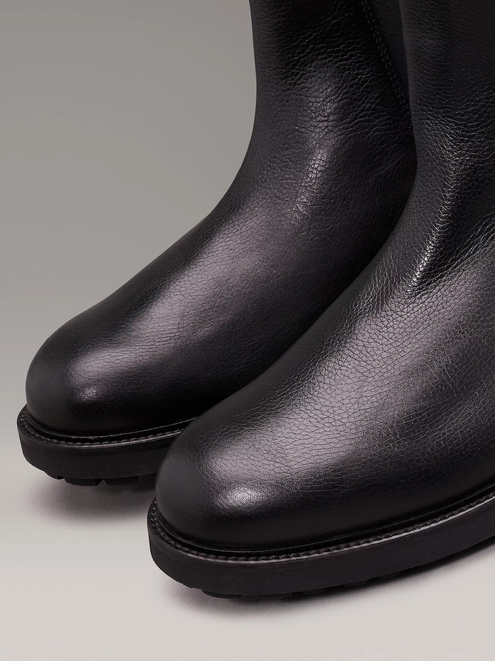 Detail view of Calvin Klein CHELSEA BOOTS Mens Ck Black, showing the smooth leather upper and round toe shape.