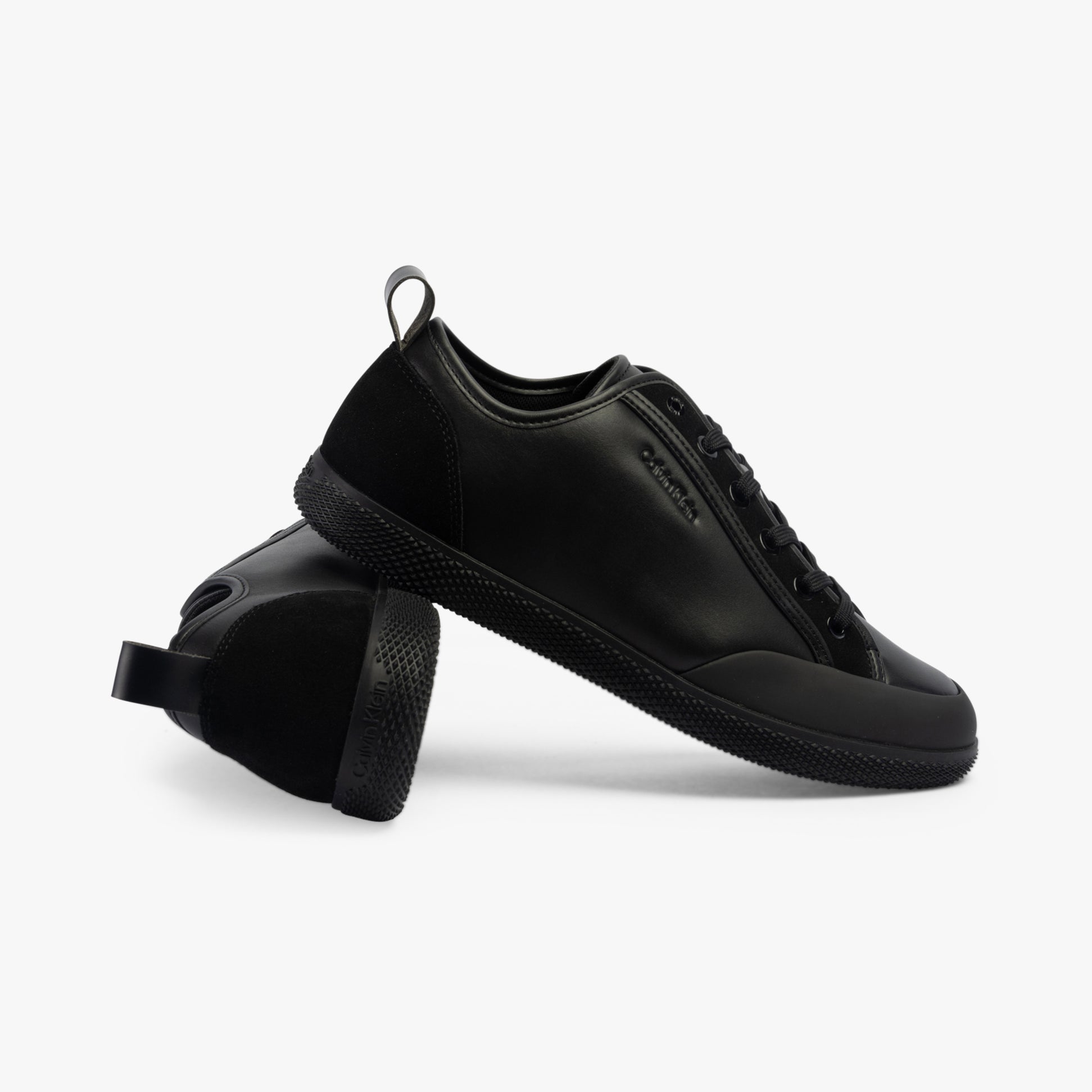 Calvin Klein LOW TOP LACE UP Mens Trainers Triple Black side view showcasing leather upper and rubber sole.