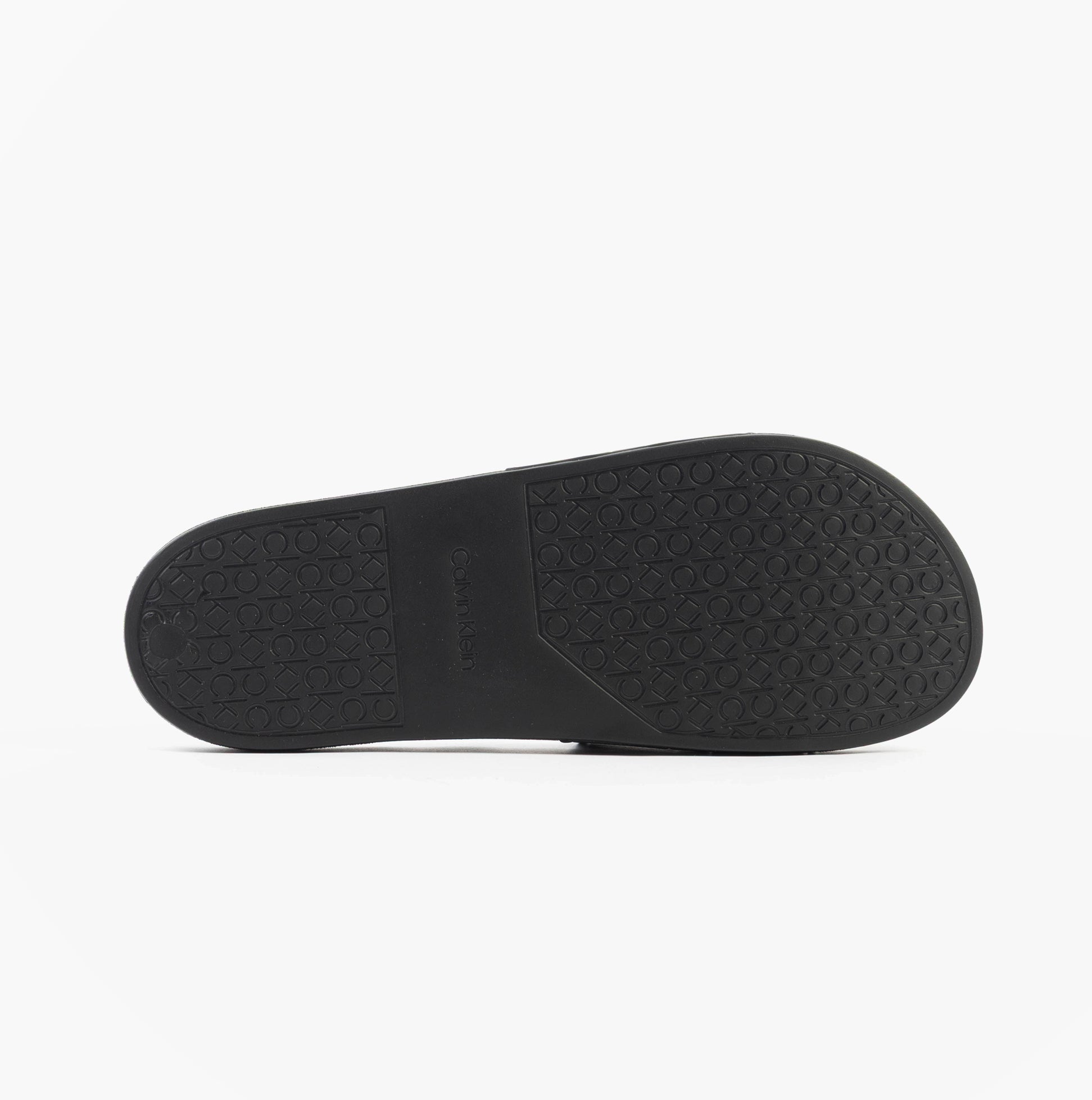 Calvin Klein POOL SLIDE DOUBLE T Mens Sliders Ck Black bottom view showing textured rubber sole for grip and durability.