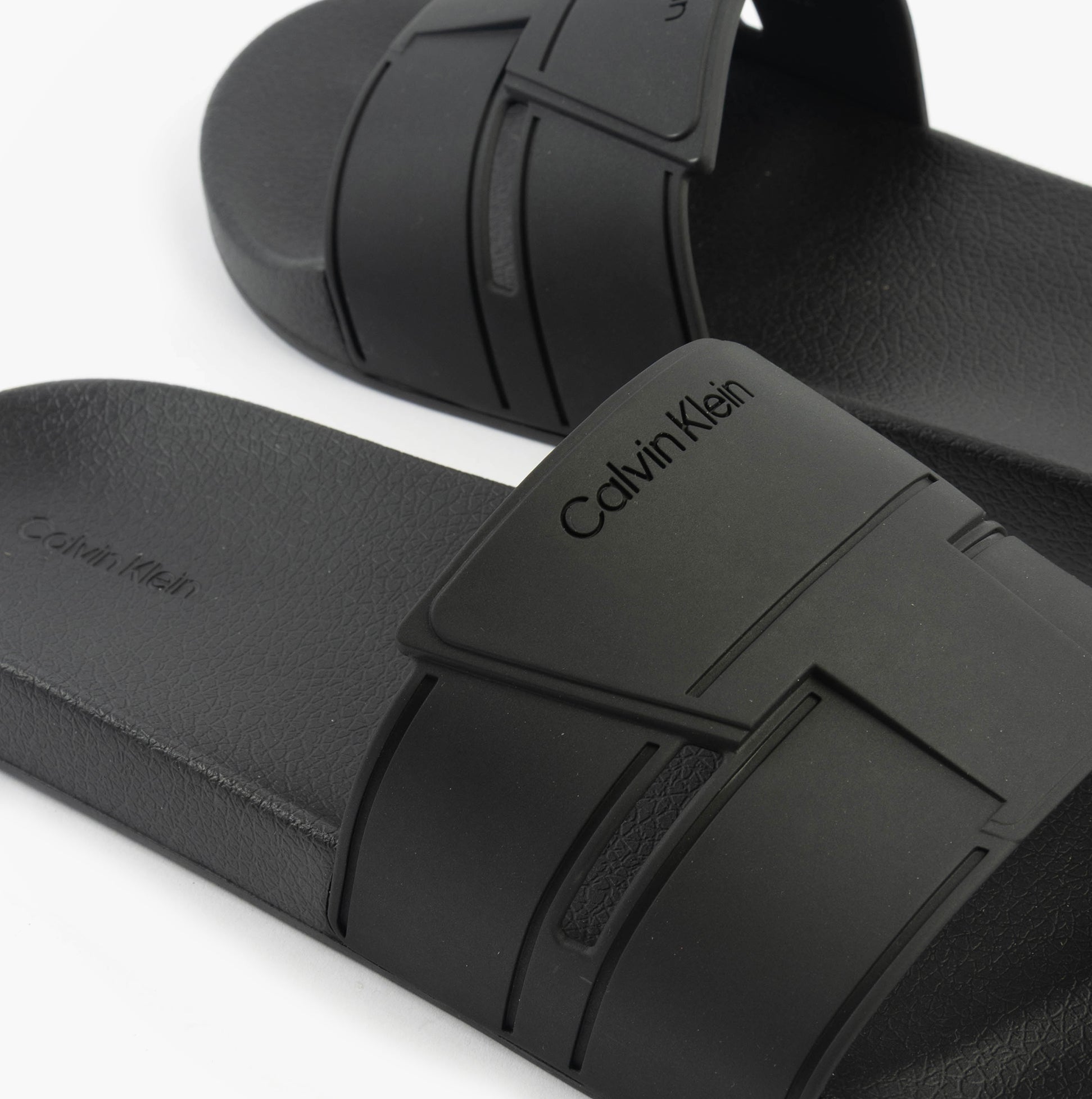 Calvin Klein POOL SLIDE DOUBLE T Mens Sliders Ck Black top view showcasing sleek design and brand logo.