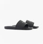 Calvin Klein POOL SLIDE W/ CK SQU Mens Sliders Black side view showing slip-on design and lightweight synthetic material.