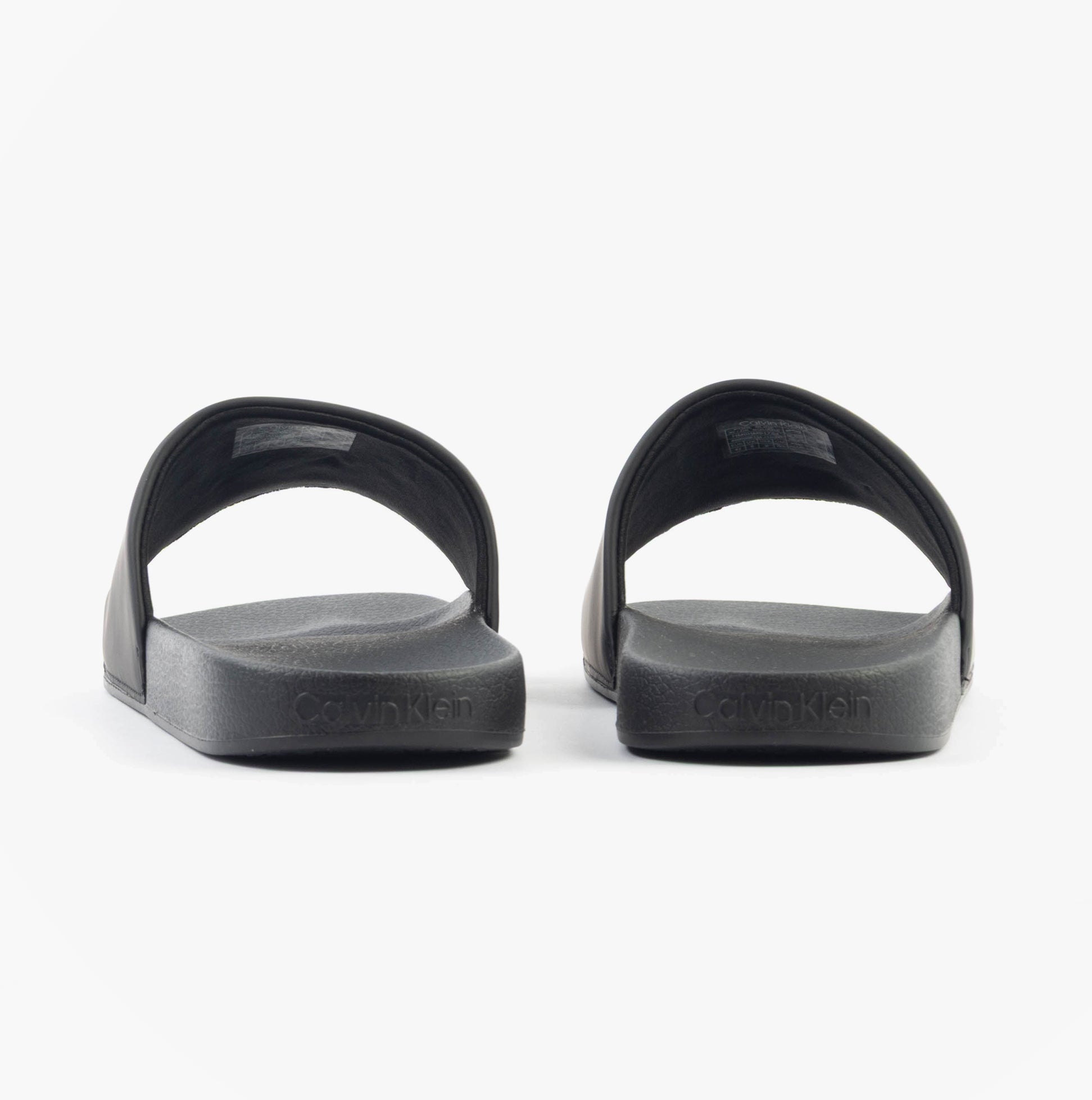 Calvin Klein POOL SLIDE W/ CK SQU Mens Sliders Black rear view with soft synthetic material and rubber sole.
