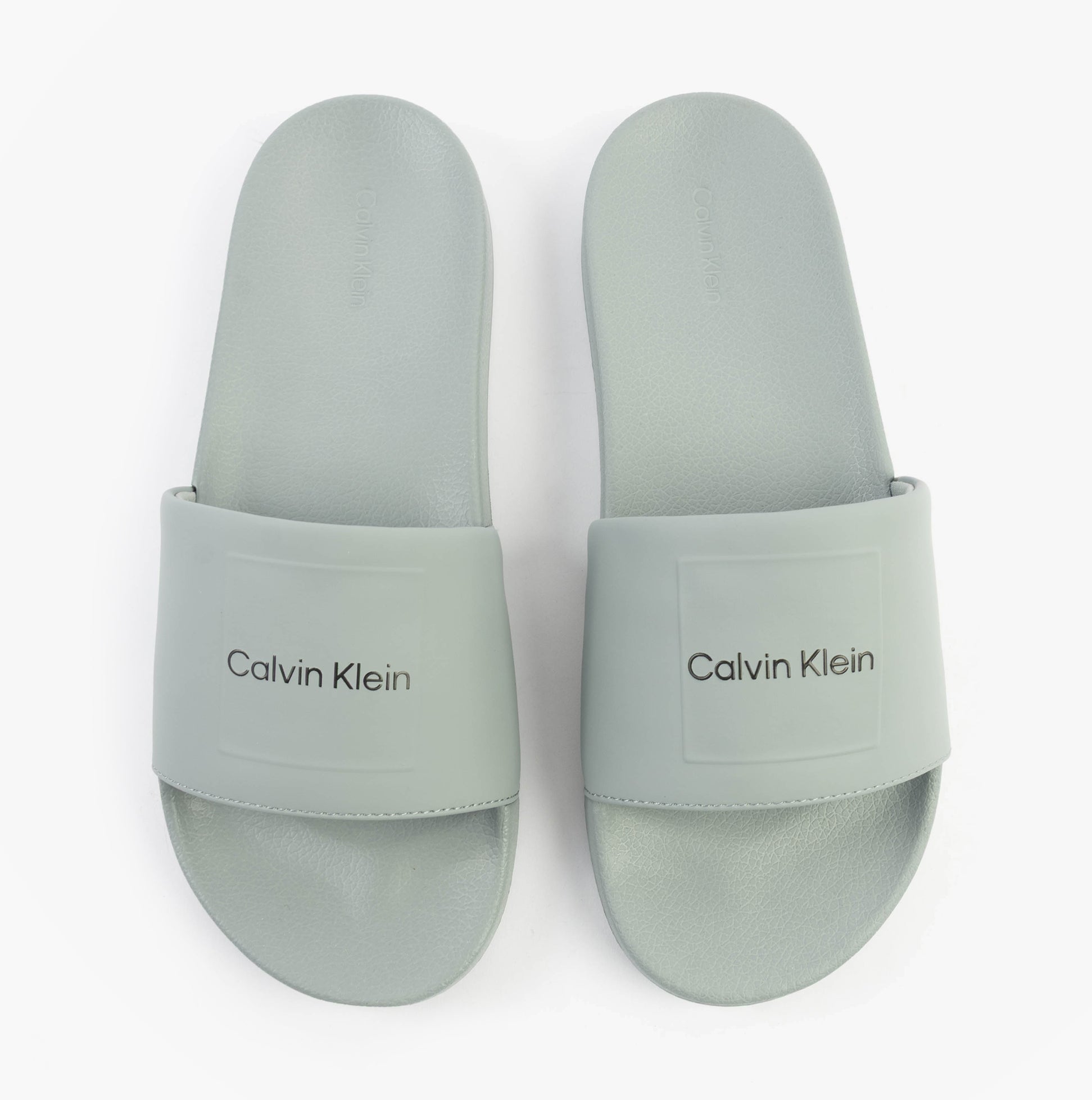 Calvin Klein POOL SLIDE W/ CK SQU Mens Sliders Granite Road top view of soft grey sliders showcasing logo