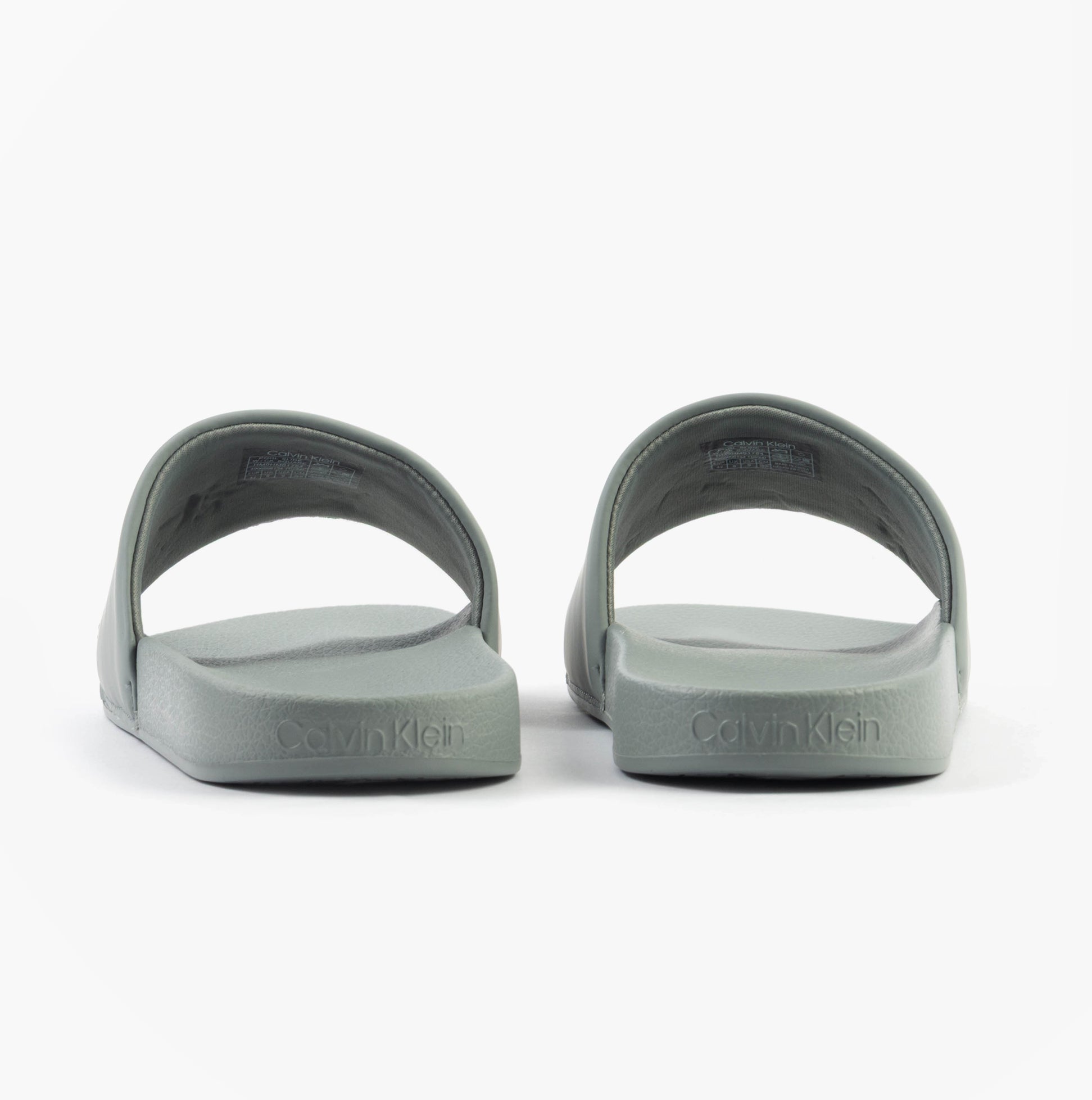 Calvin Klein POOL SLIDE W/ CK SQU Mens Sliders Granite Road back view showing the grey synthetic upper and flat sole.