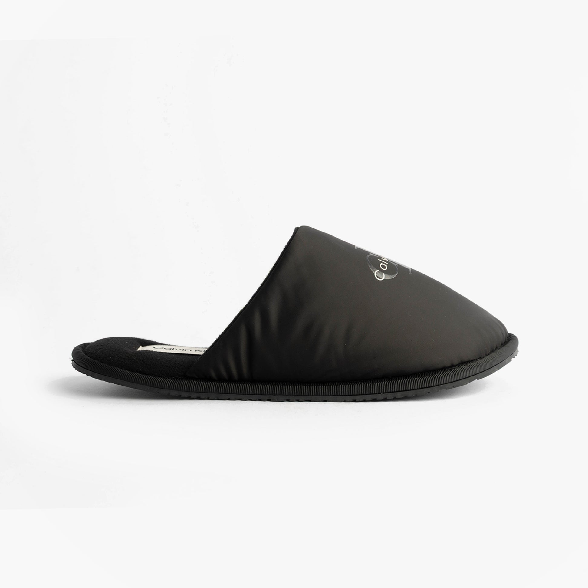 Calvin Klein HOTEL SLIPPER MONOLOGUE Mens Slippers Triple Black side view showing the comfortable slip-on mule design.