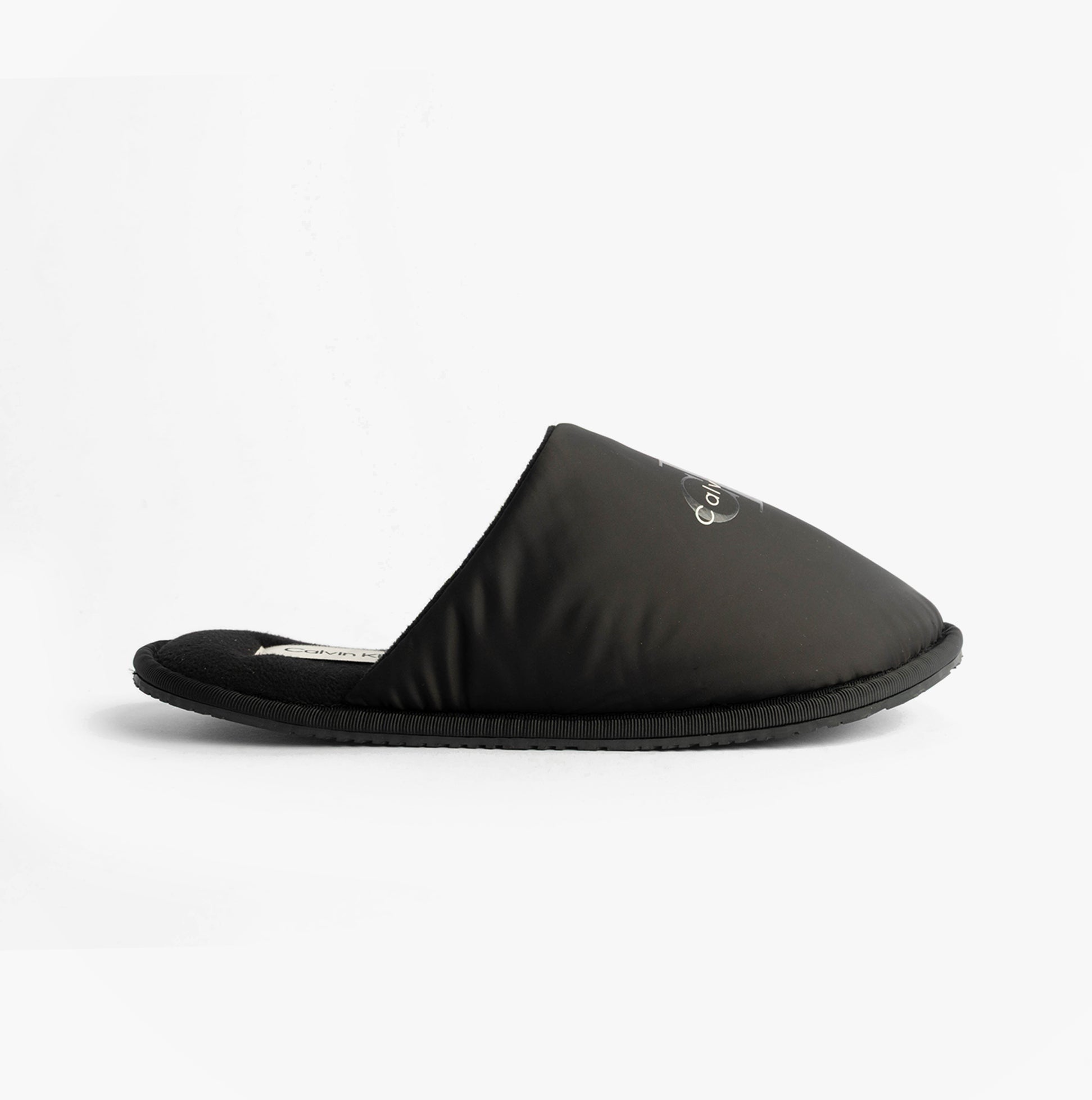 Calvin Klein HOTEL SLIPPER MONOLOGUE Mens Slippers Triple Black side view showing the comfortable slip-on mule design.