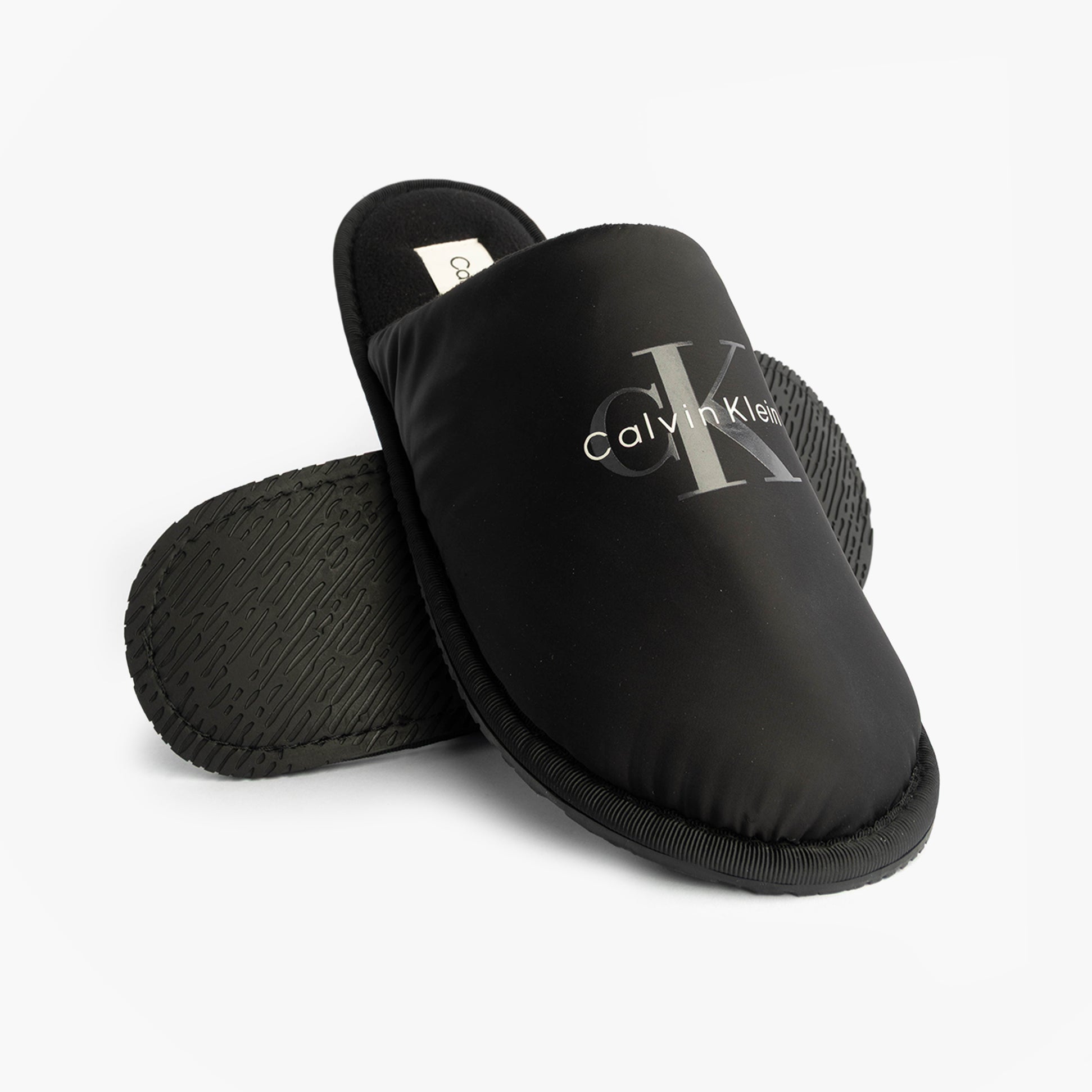 Calvin Klein HOTEL SLIPPER MONOLOGUE Mens Slippers Triple Black side view showing slip-on design and logo.