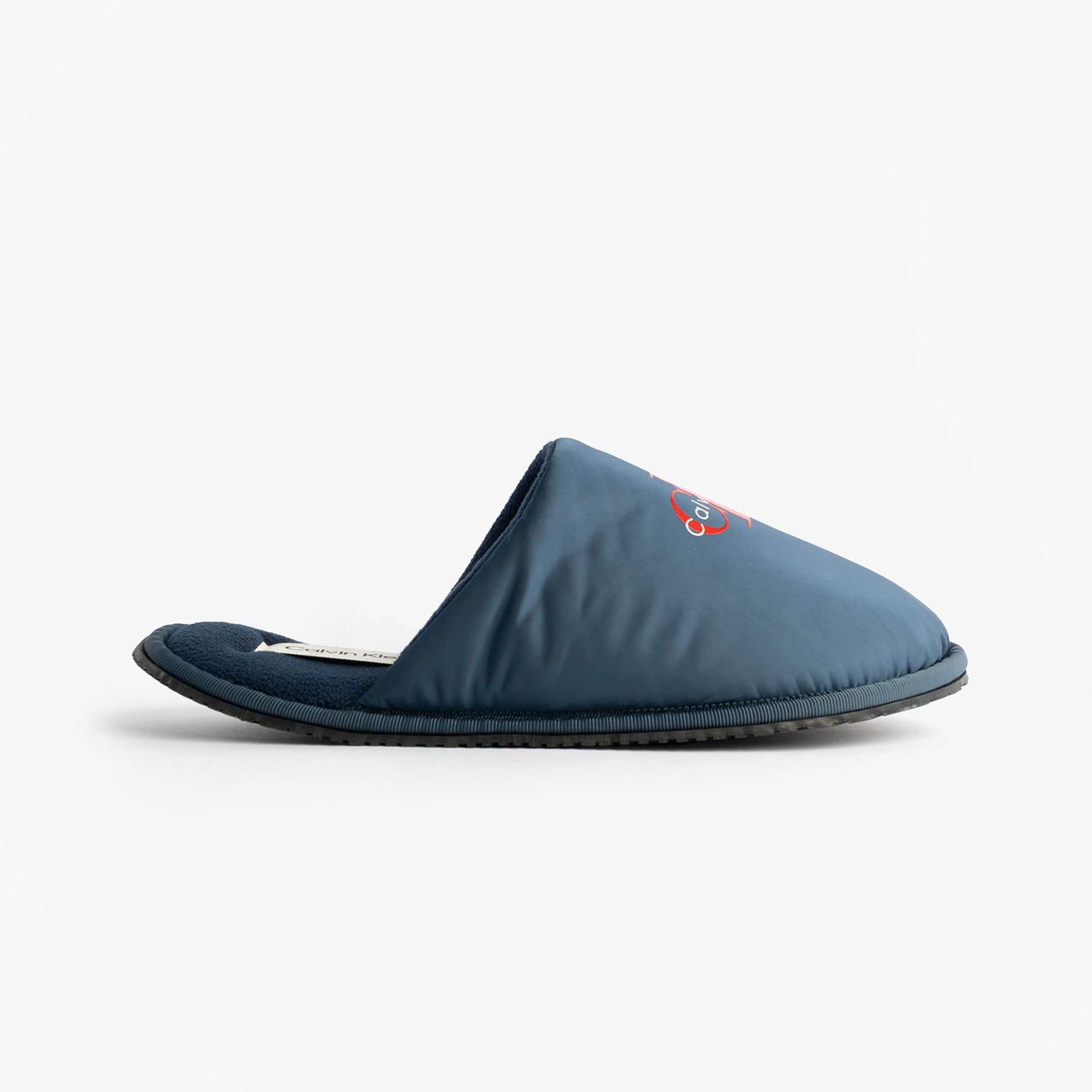 Calvin Klein HOTEL SLIPPER MONOLOGUE Mens Slippers Moonlit Ocean side view of blue slip-on mules with embroidered detail.