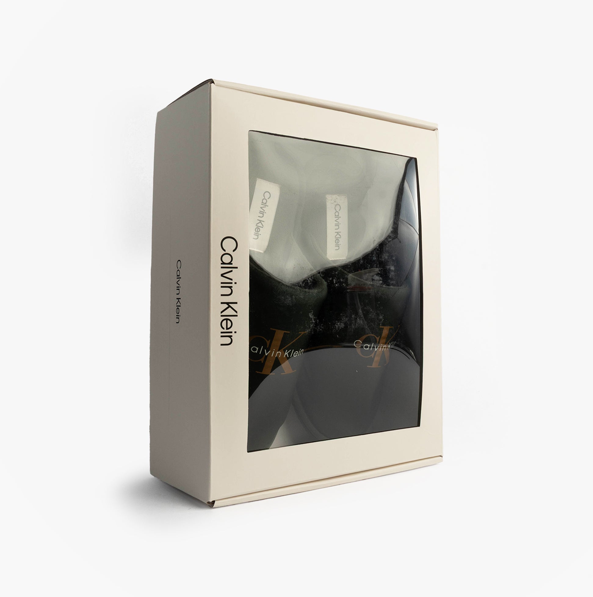 Calvin Klein HOTEL SLIPPER MONOLOGUE Mens Slippers Thyme in gift box side view with branding and clear window display.