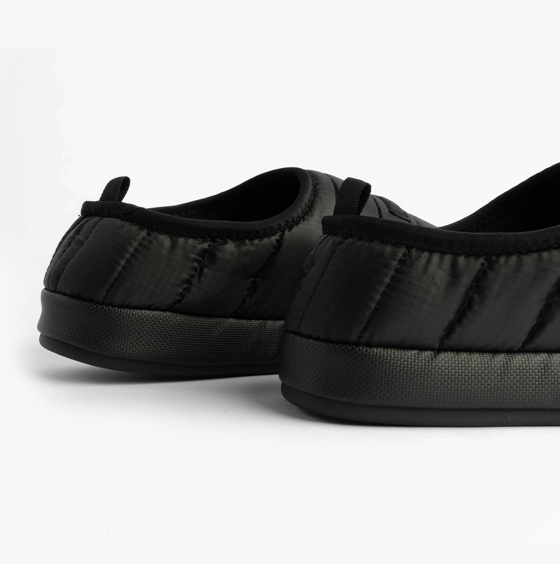 Calvin Klein HOME SLIPPER RIPSTOP Mens Slippers Black side view showing the soft, quilted texture and slip-on design.