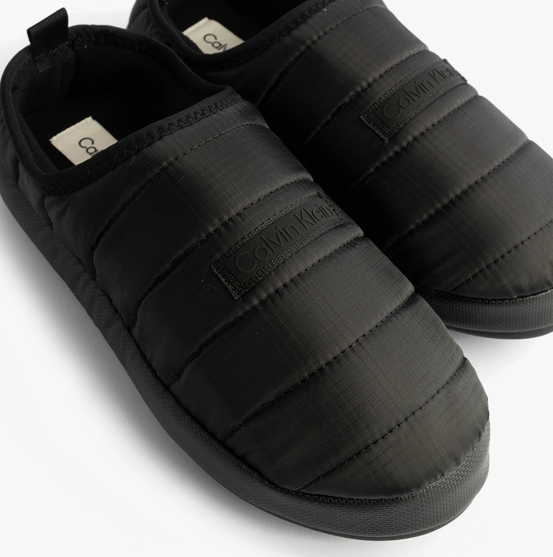 Calvin Klein HOME SLIPPER RIPSTOP Mens Slippers Black top view, featuring padded design and slip-on style.