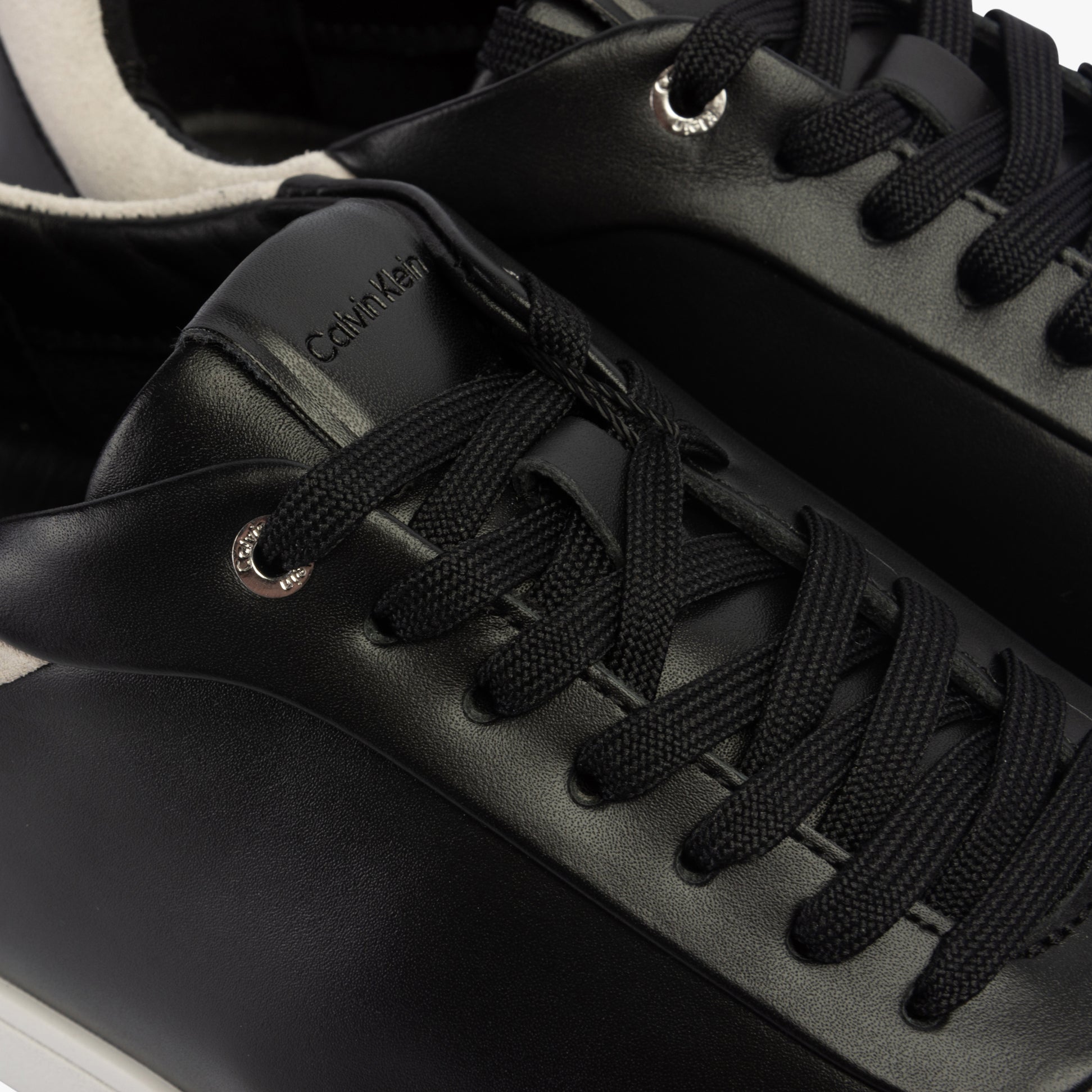Calvin Klein CUPSOLE LACE UP Womens Trainers Black/White detail view highlighting the leather upper and lace-up closure.