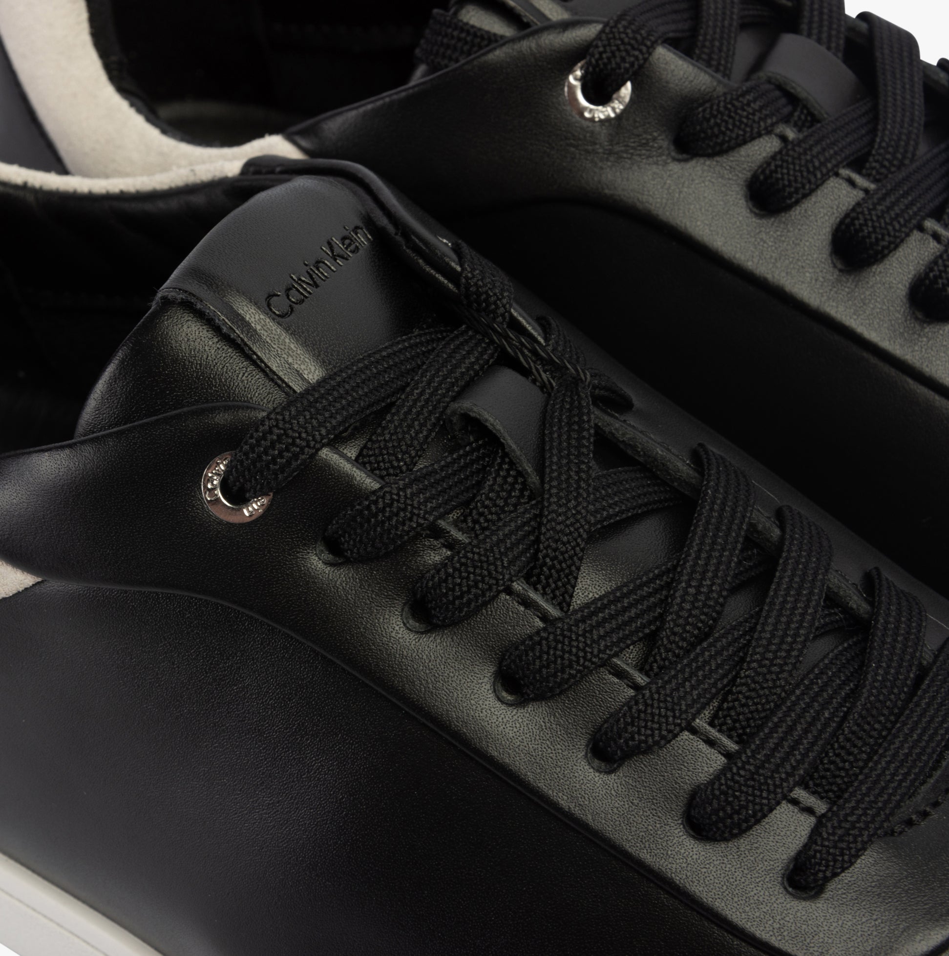 Calvin Klein CUPSOLE LACE UP Womens Trainers Black/White detail view highlighting the leather upper and lace-up closure.