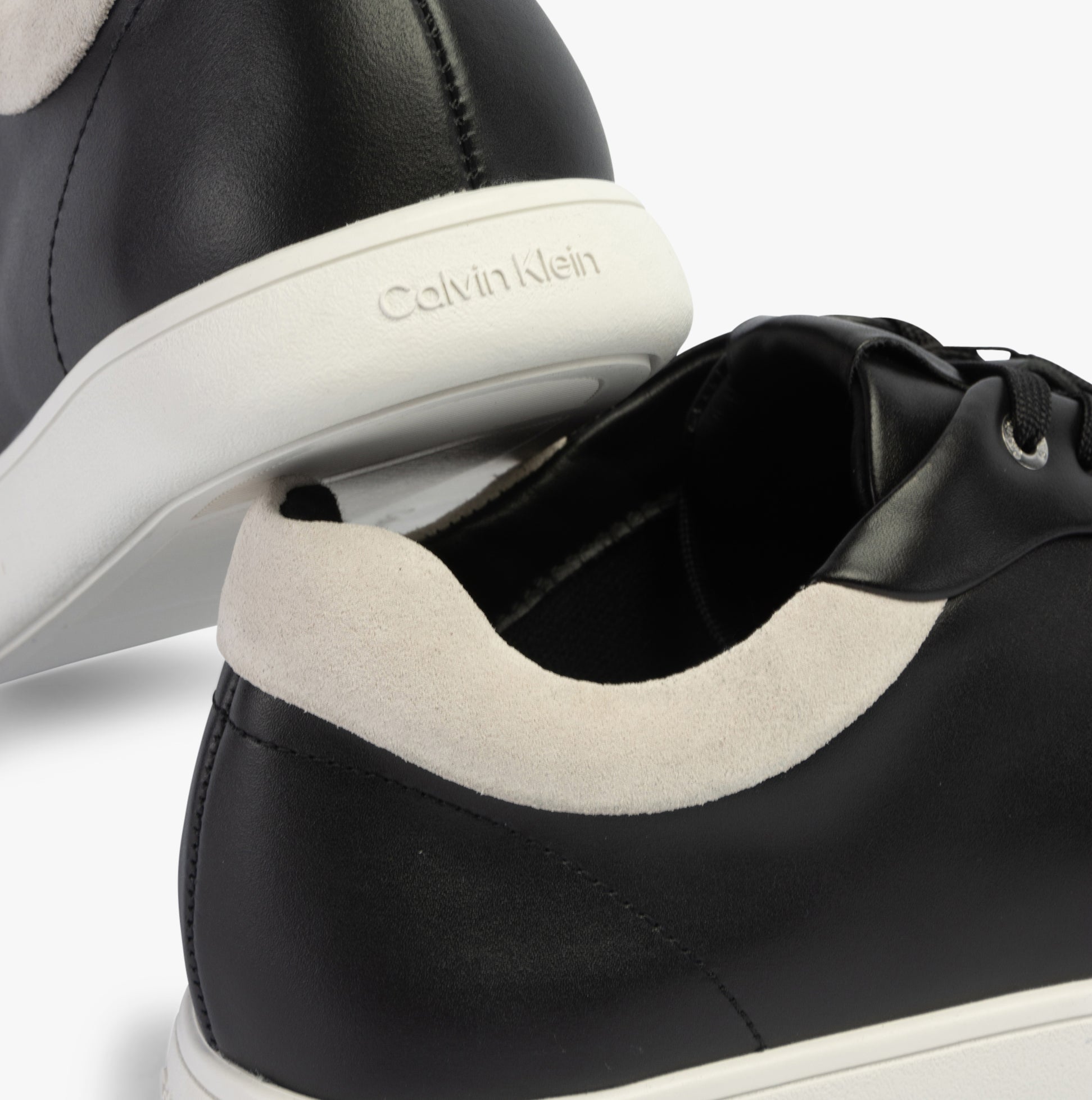 Calvin Klein CUPSOLE LACE UP Womens Trainers Black/White, side view showing smooth leather upper and textured heel detail.