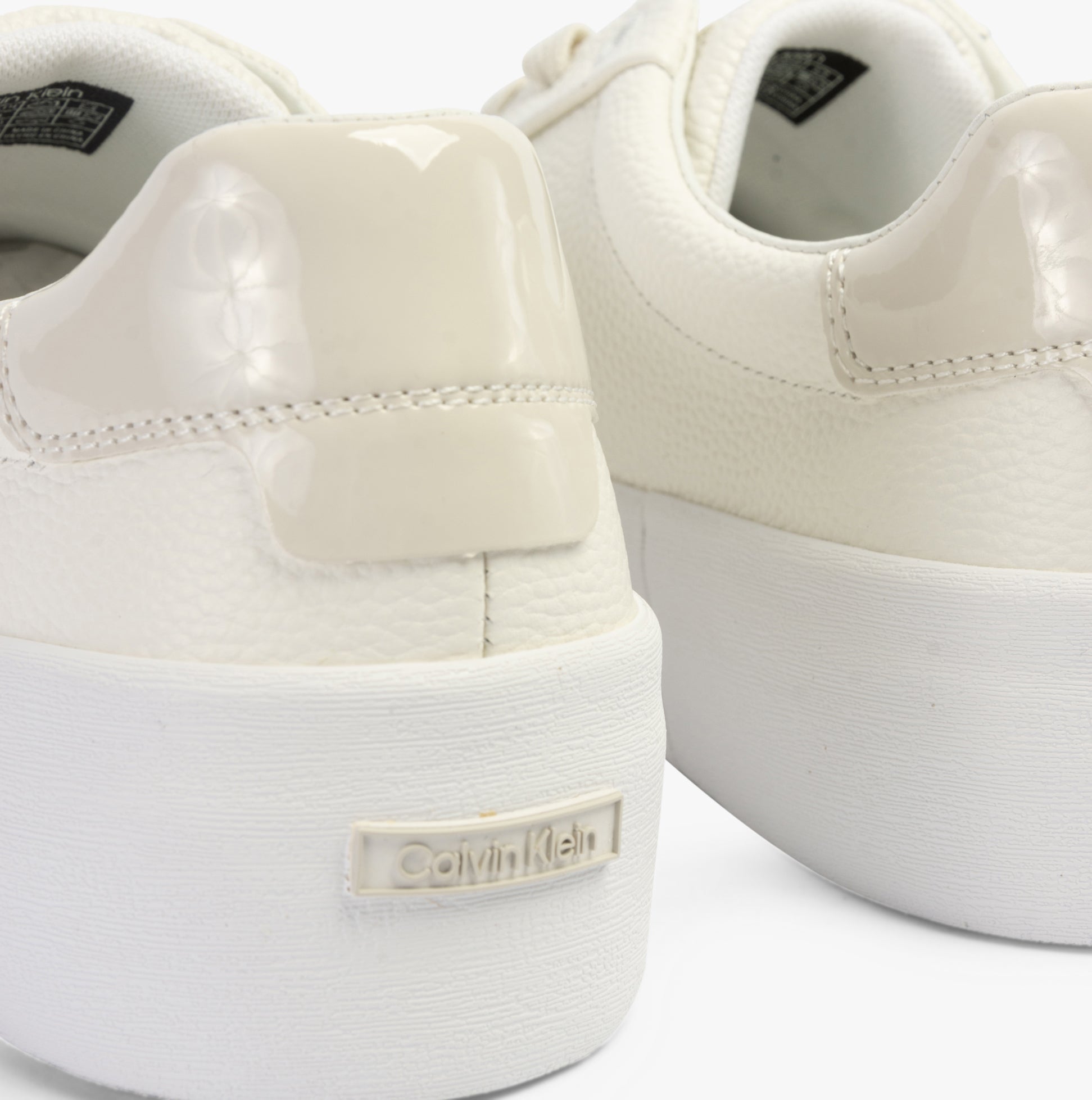 Calvin Klein VULCANISED LACE UP Womens Trainers White/Dk Ecru rear view highlighting the shiny heel and brand logo.