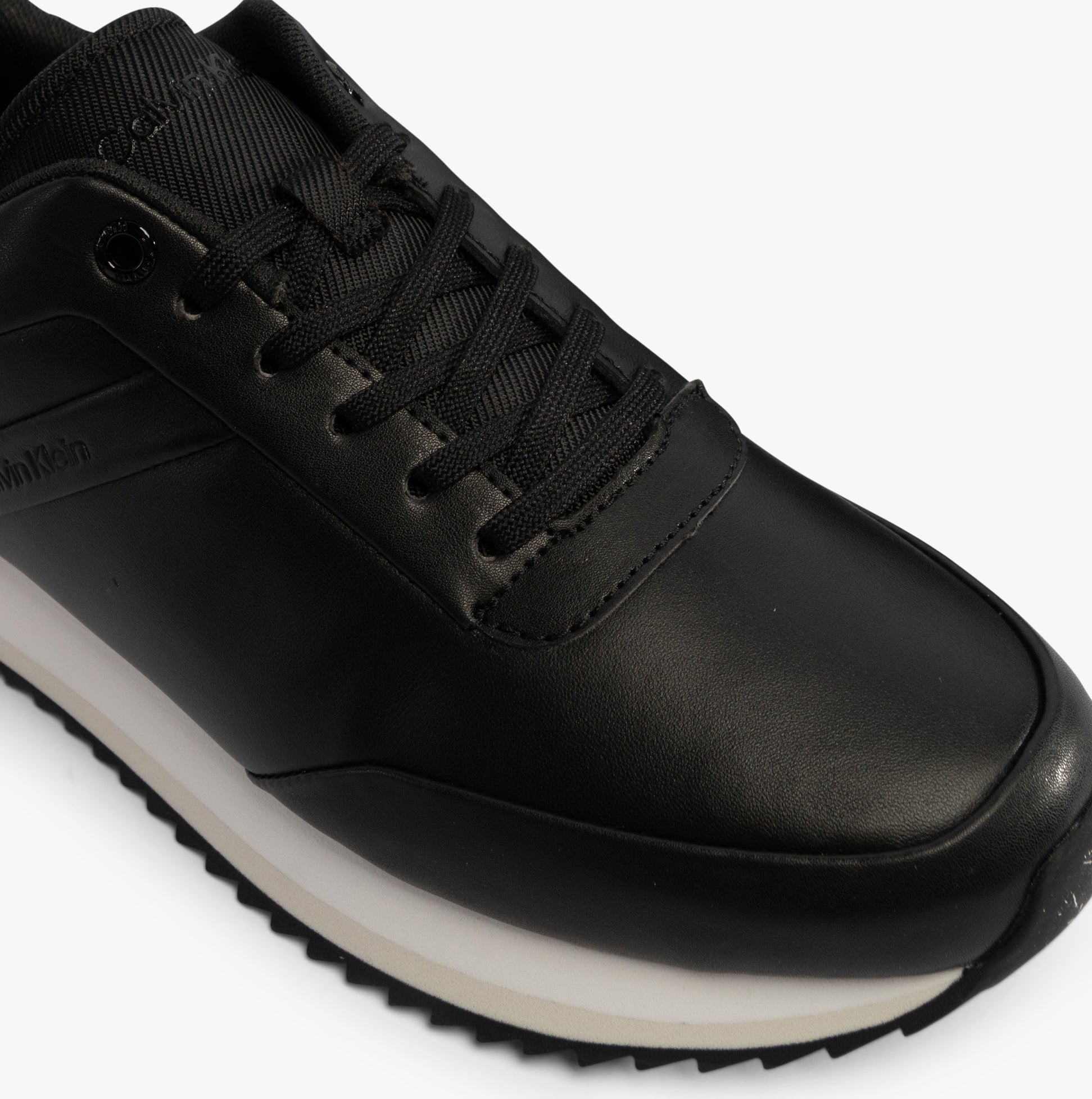 Calvin Klein RUNNER LACE UP Womens Trainers Ck Black top view showing lace-up design and leather upper.