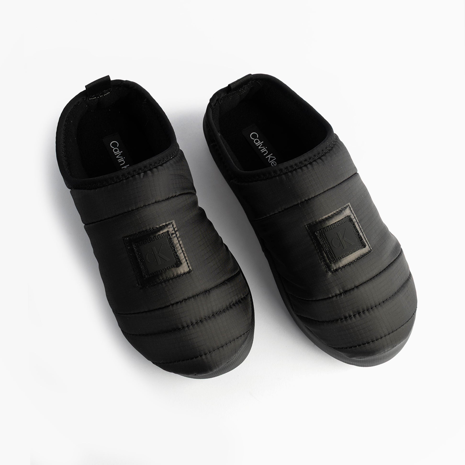 Calvin Klein HOME SLIPPER NYL PAT Womens Slippers Black top view showing stylish design and comfortable fit.