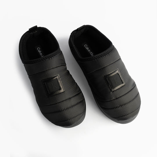 Calvin Klein HOME SLIPPER NYL PAT Womens Slippers Black top view showing stylish design and comfortable fit.