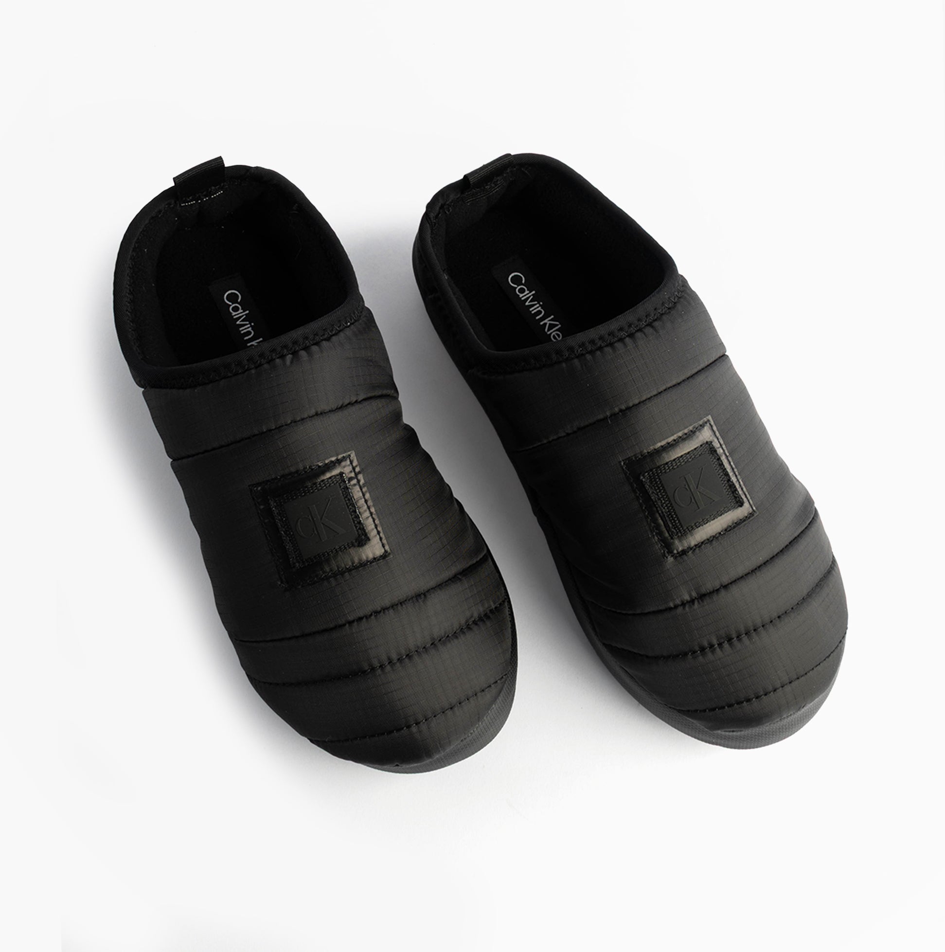 Calvin Klein HOME SLIPPER NYL PAT Womens Slippers Black top view showing stylish design and comfortable fit.