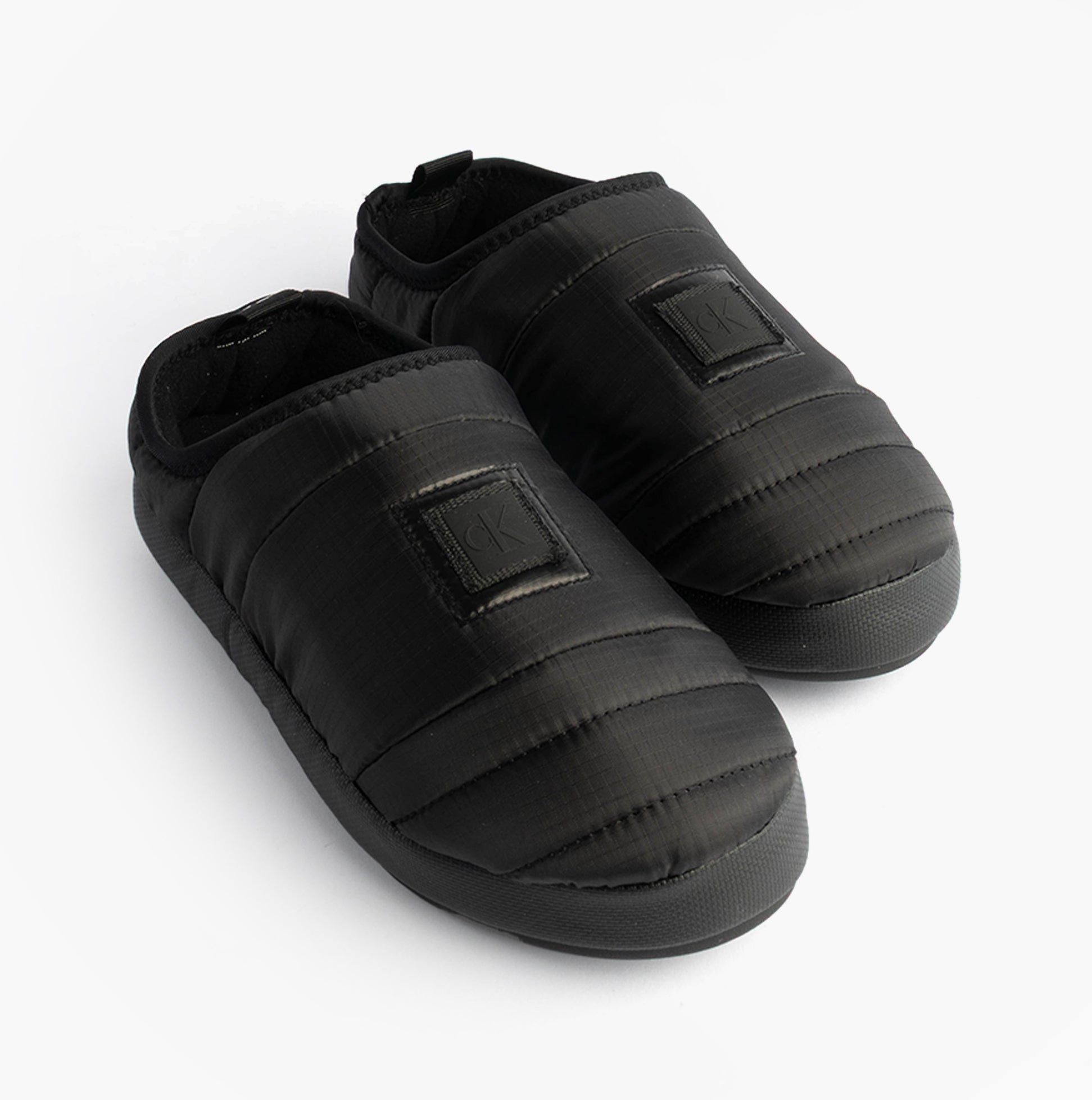 Calvin Klein HOME SLIPPER NYL PAT Womens Slippers Black side view, lightweight polyester upper, slip-on full slippers.