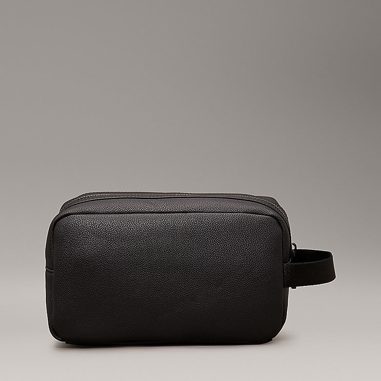 Calvin Klein WARMTH WASHBAG Mens Black side view showcasing faux leather exterior and zip closure.