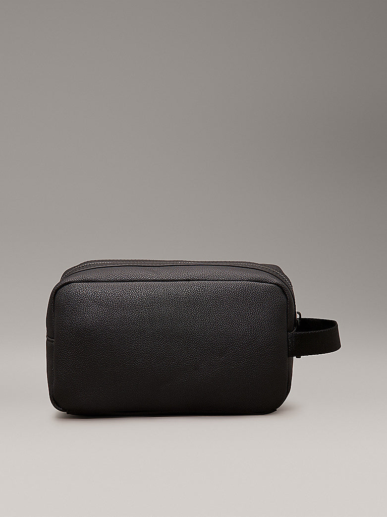 Calvin Klein WARMTH WASHBAG Mens Black side view showcasing faux leather exterior and zip closure.