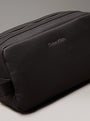 Calvin Klein WARMTH WASHBAG Mens Black front view with zip closure and CK logo on faux leather exterior.