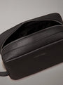 Calvin Klein WARMTH WASHBAG Mens Black top view with zip open, showcasing faux leather texture and CK logo.