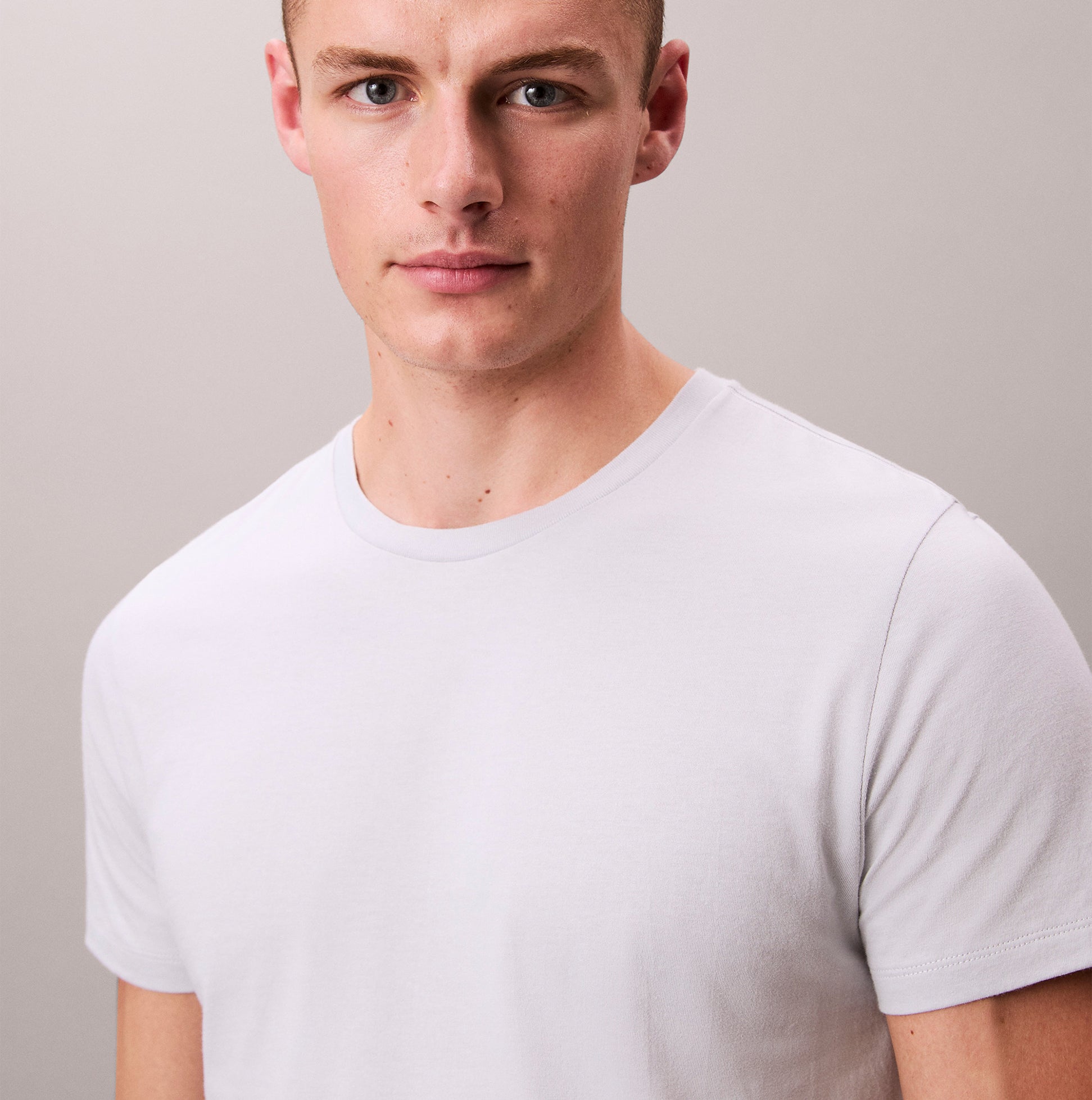 Calvin Klein 3 Pack Mens Crew neck T-Shirt Cotton Classics Multi Colour front view of a model wearing a white t-shirt.