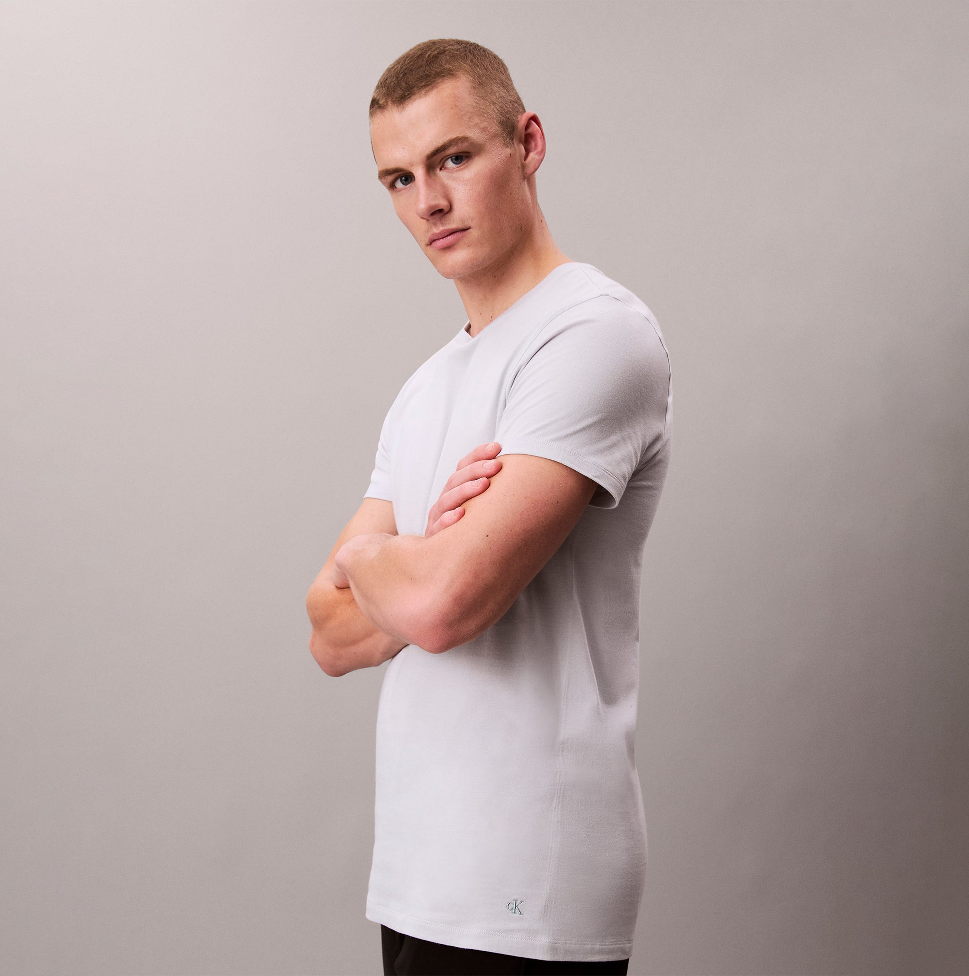 Calvin Klein 3 Pack Mens Crew neck T-Shirt Cotton Classics Multi Colour side view of model wearing light grey tee.