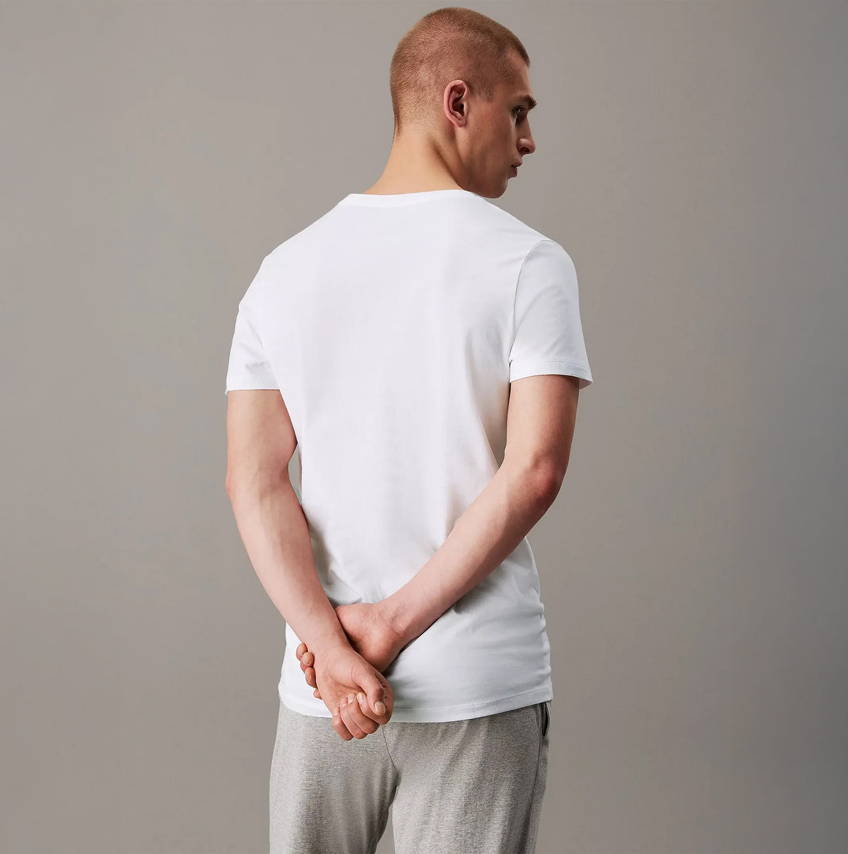 Calvin Klein 100% COTTON 3 Pack Mens T-Shirts White back view of model wearing t-shirt, showcasing lightweight cotton fabric.
