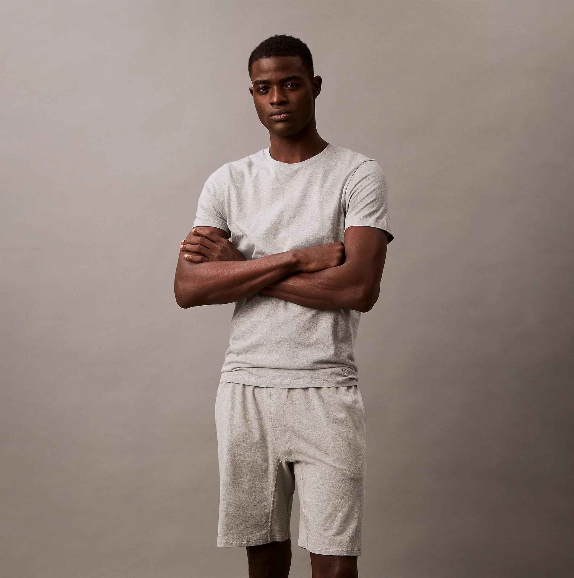 Calvin Klein 100% COTTON 3 Pack Mens T-Shirts Black/Grey Heather/Glacier front view model wearing heather grey t-shirt and shorts.