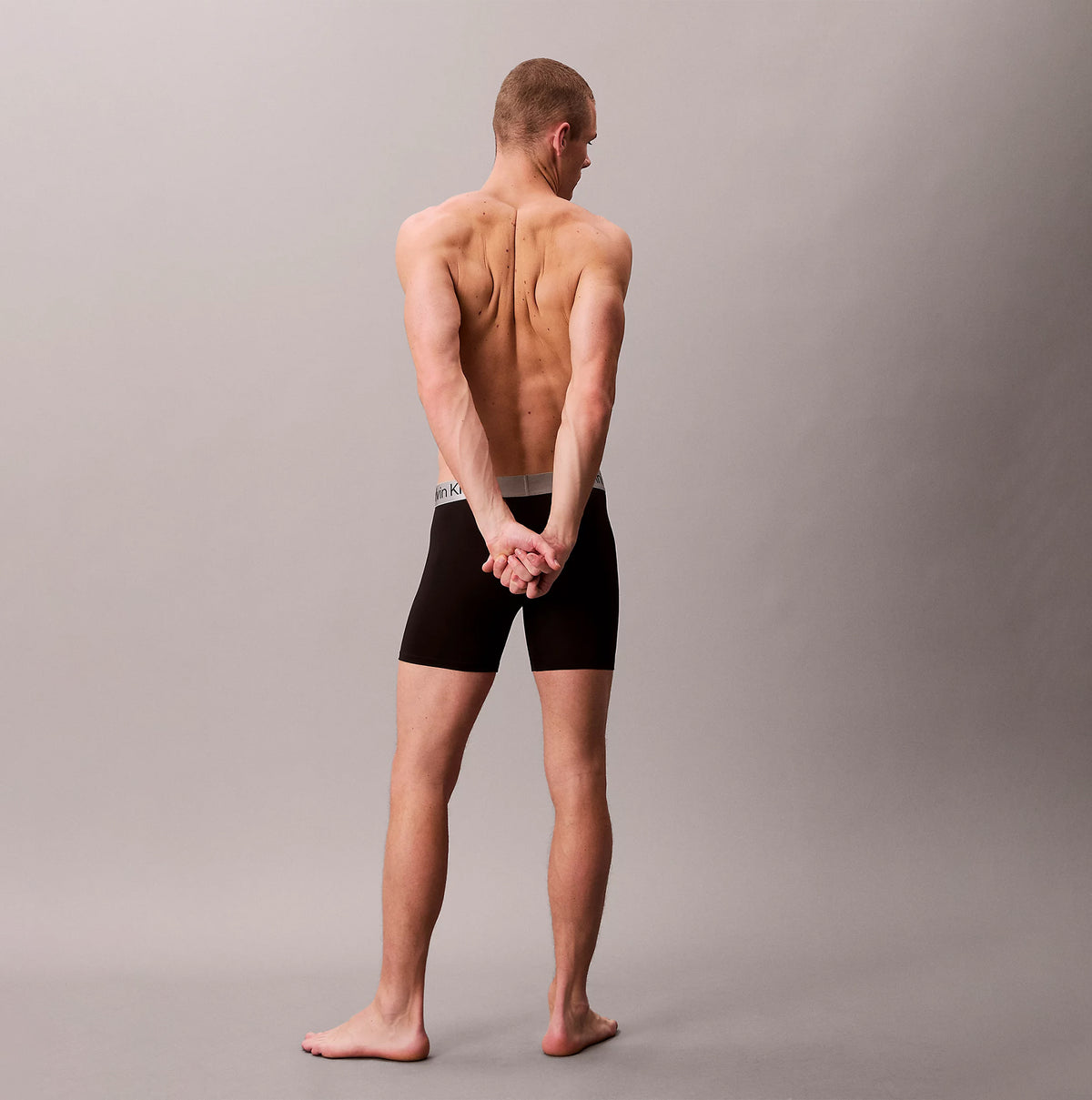 Calvin Klein LV00NB4124 BOXER BRIEF 3 PACK Mens Low Rise Trunks Multicoloured, back view of model wearing black trunks.