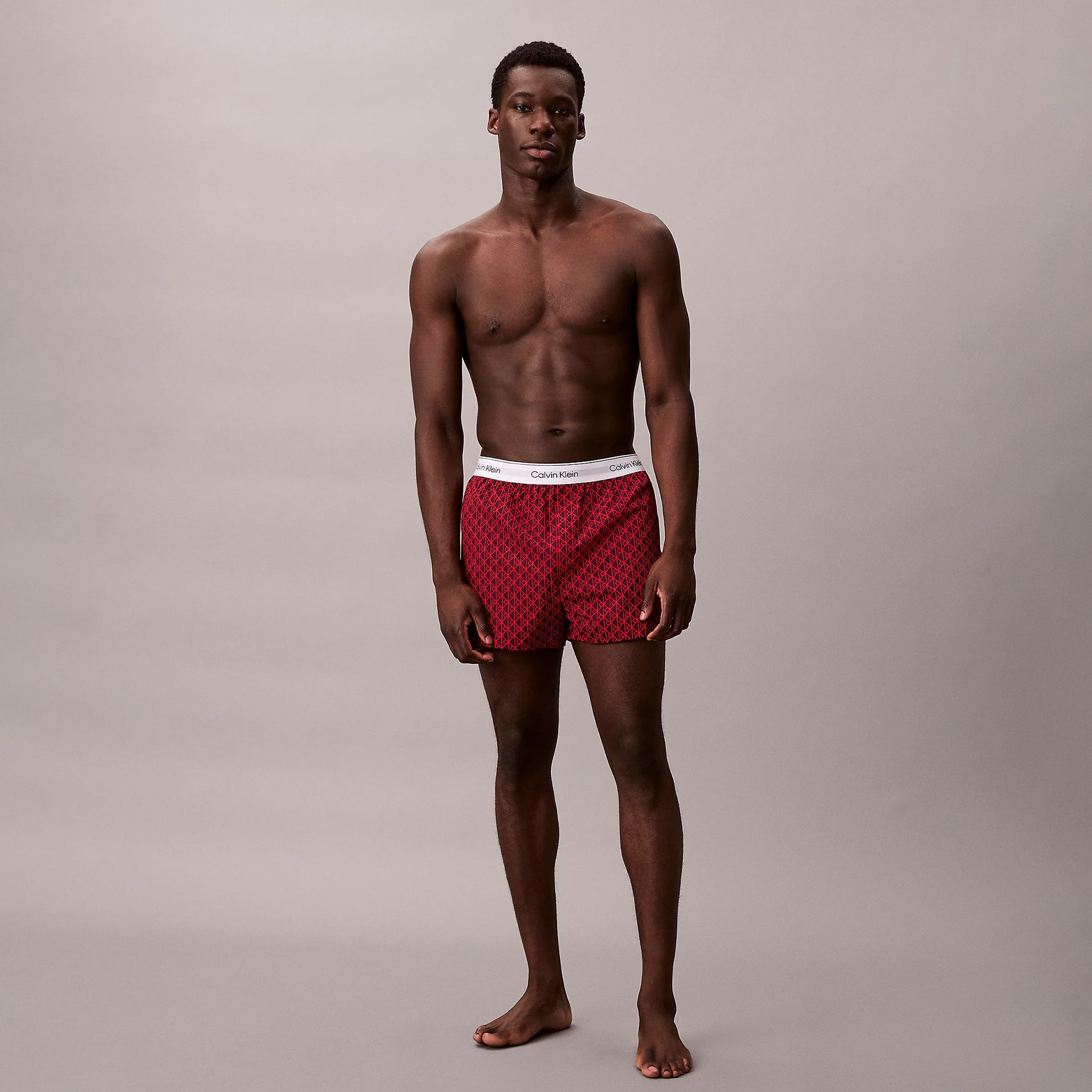 Calvin Klein BOXER SLIM 3 Pack Mens Cotton Stretch Multicoloured front view with model wearing red boxers.