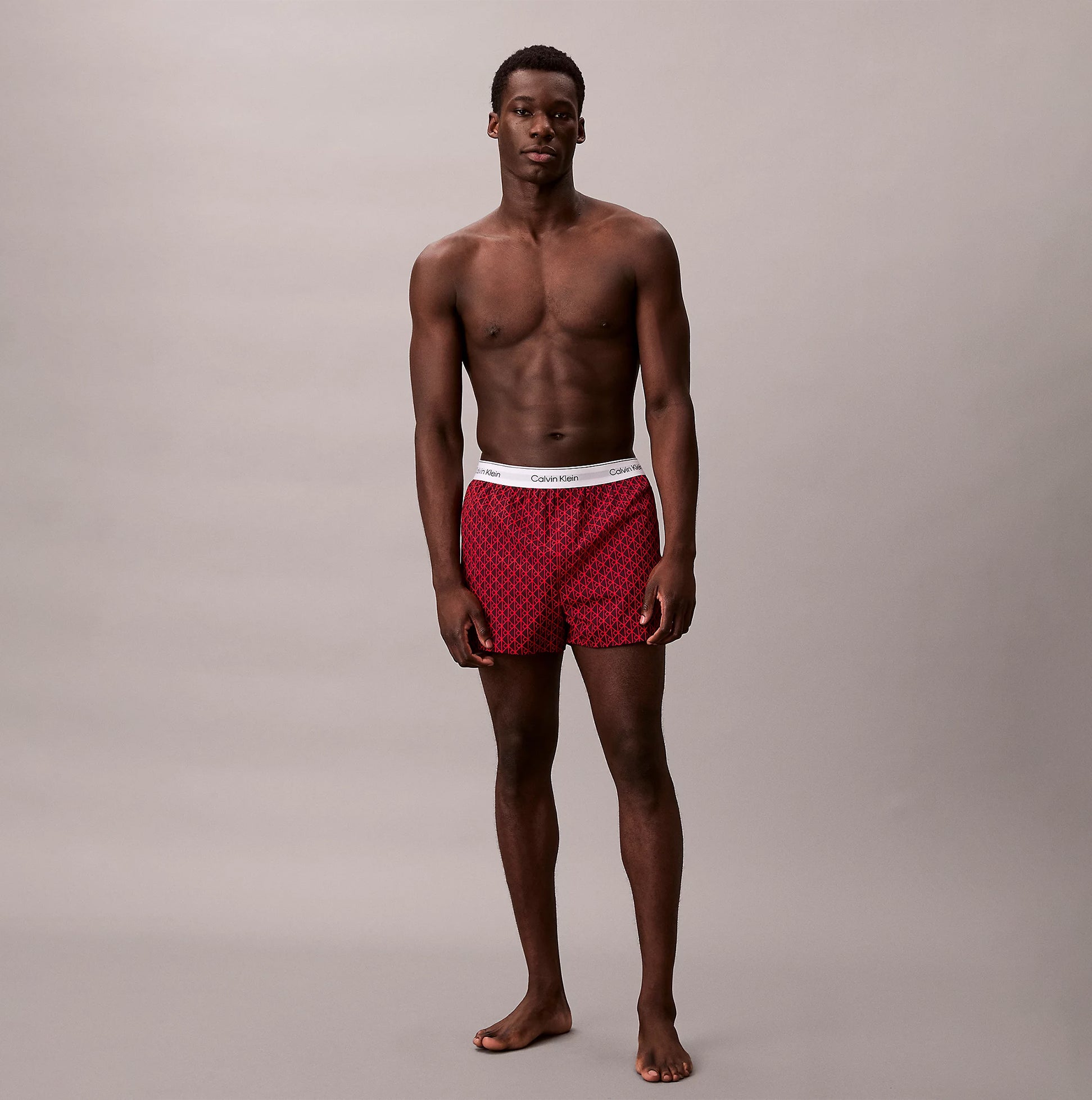 Calvin Klein BOXER SLIM 3 Pack Mens Cotton Stretch Multicoloured front view with model wearing red boxers.