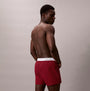 Calvin Klein BOXER SLIM 3 Pack Mens Cotton Stretch Multicoloured side view of a man wearing red boxer shorts.