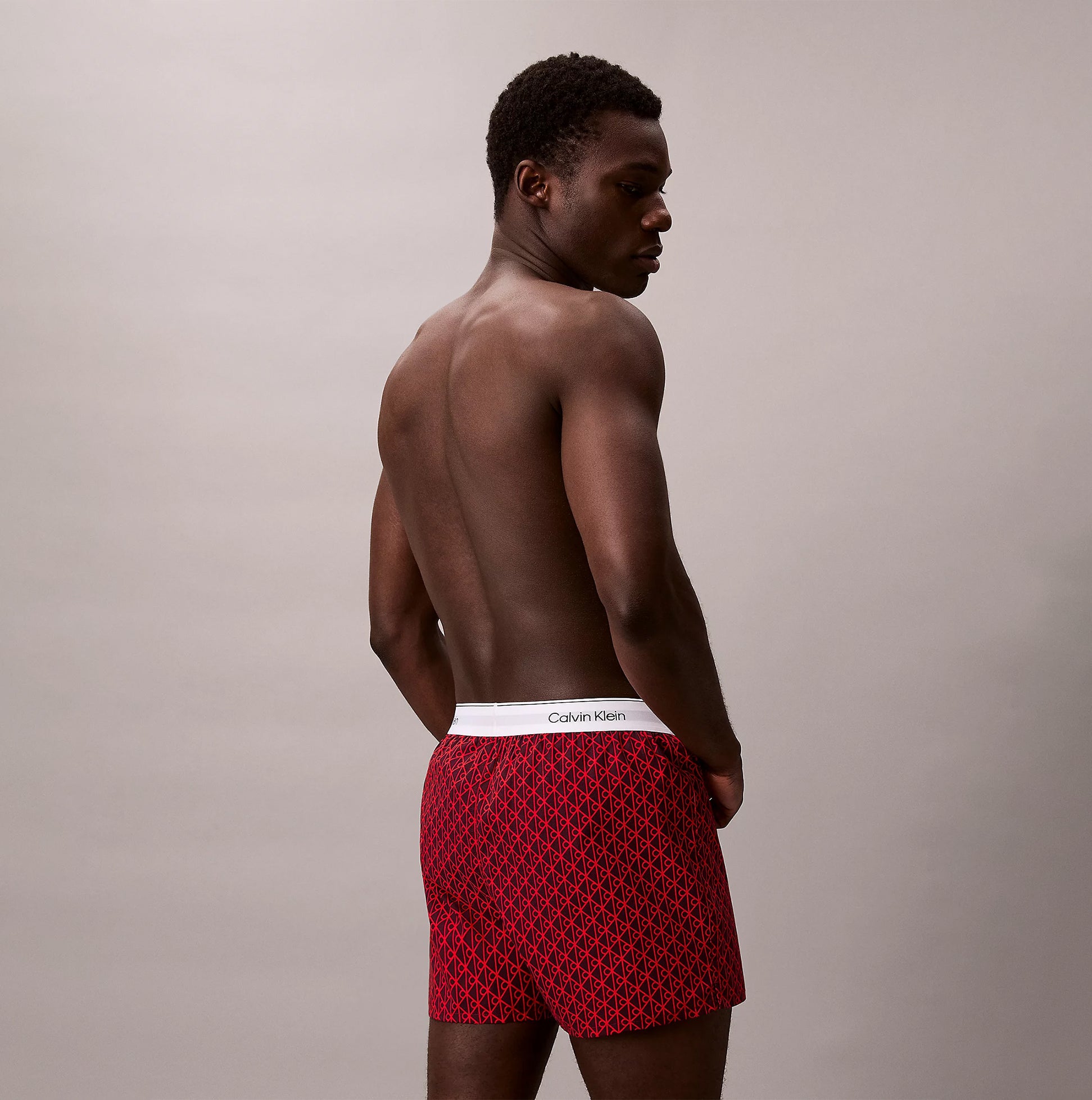 Calvin Klein BOXER SLIM 3 Pack Mens Cotton Stretch Multicoloured side view of a man wearing red boxer shorts.