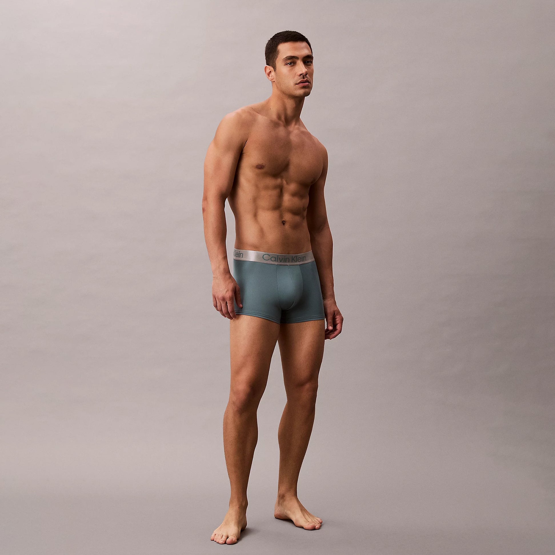 Calvin Klein TRUNK 3 Pack Mens Micro Stretch Multicoloured side view of model wearing grey trunk underwear.