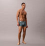Calvin Klein TRUNK 3 Pack Mens Micro Stretch Multicoloured side view of model wearing grey trunk underwear.
