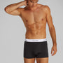 Calvin Klein ICON Cotton Stretch 3 Pack Dart Trunks Black/White side view of model wearing black trunks with CK waistband.
