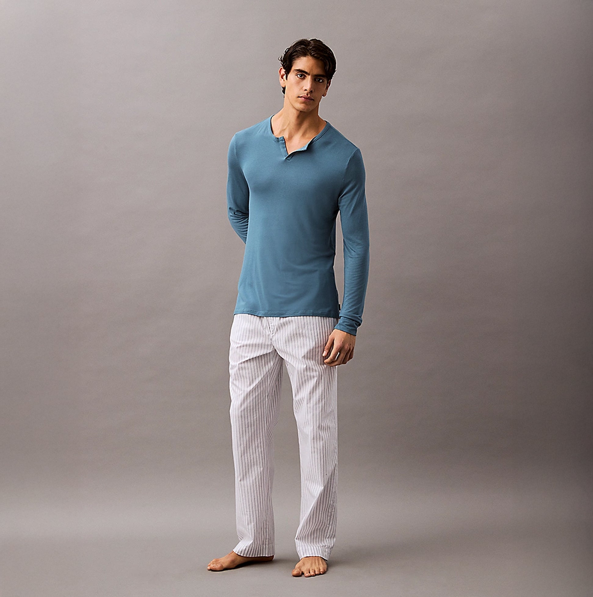 Calvin Klein ULTRA SOFT MODAL Mens Pyjama Top Deck Gray front view, model wearing long-sleeve top and striped pants.