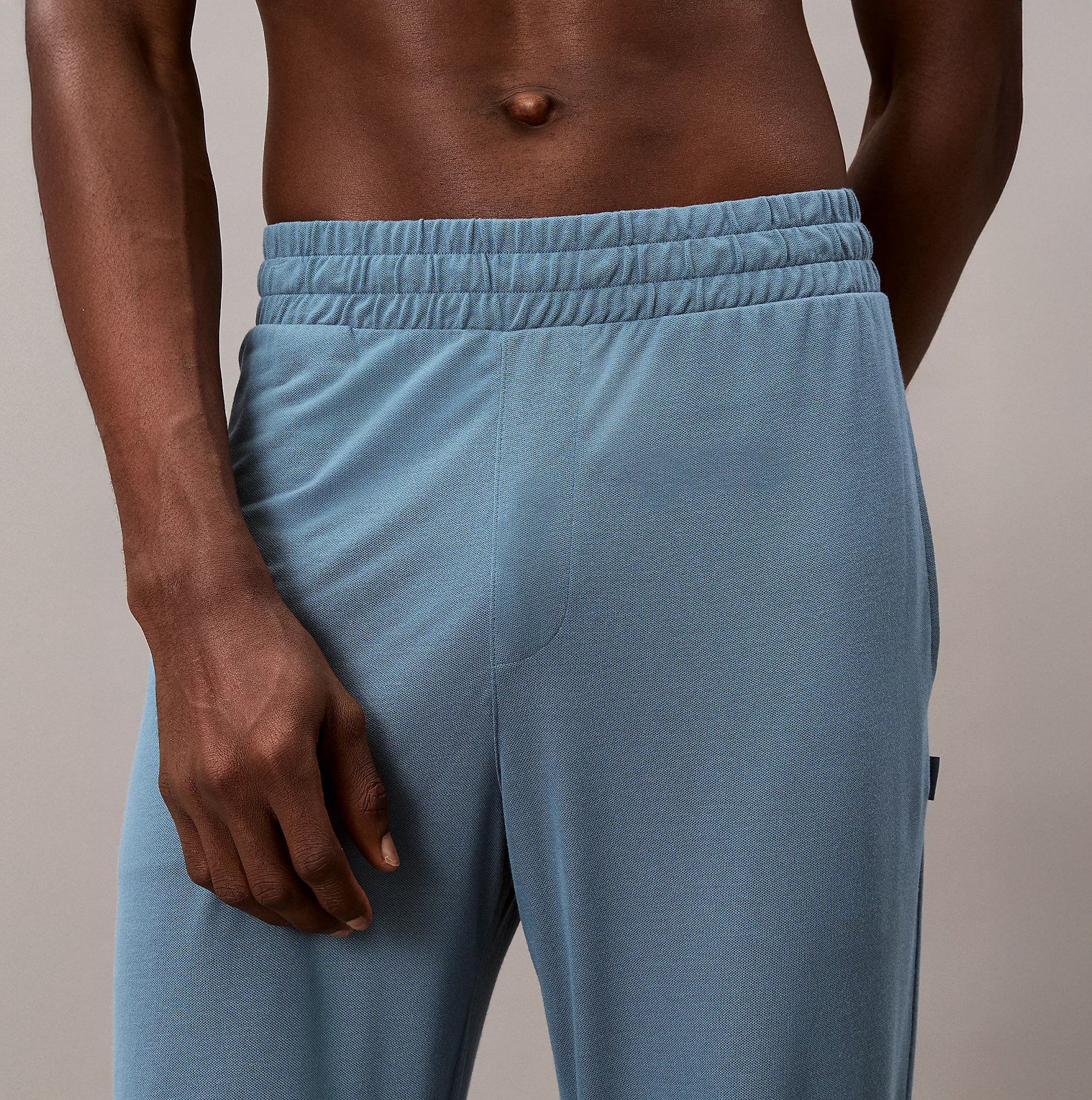 Calvin Klein SLEEP PANT Mens Deck Gray side view highlighting elastic waist and tapered leg details.