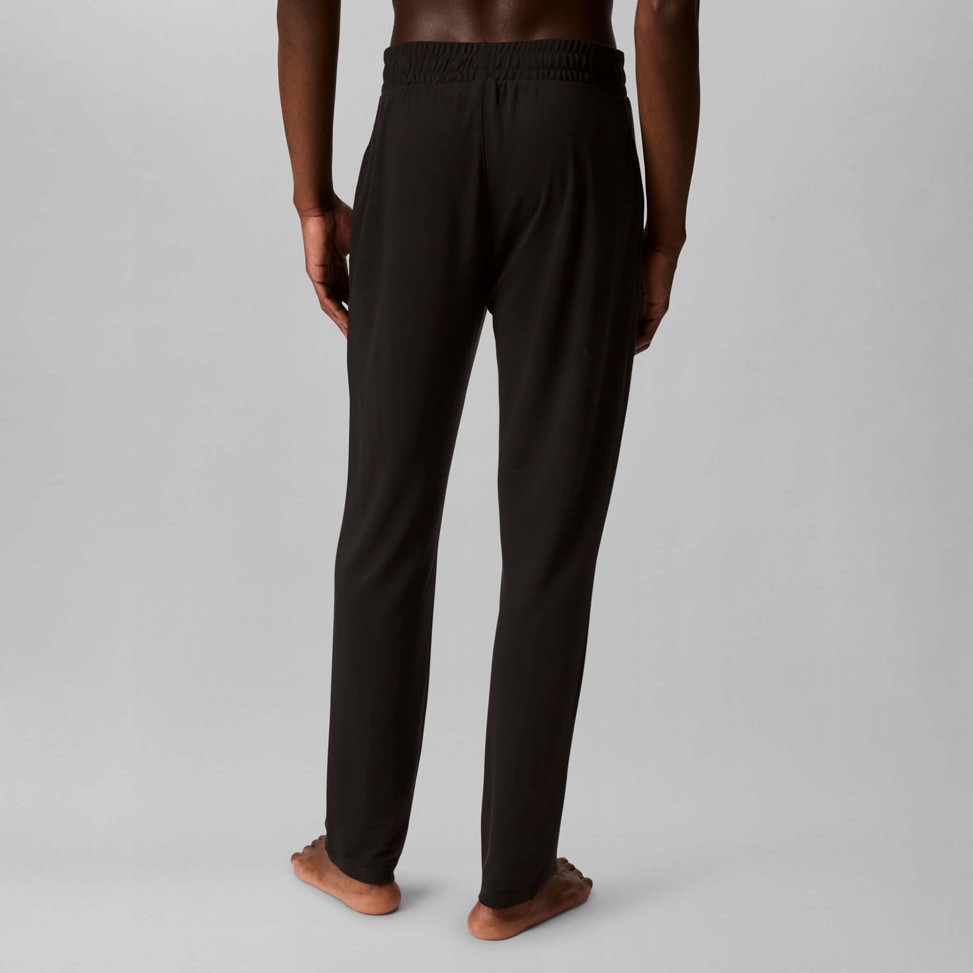 Calvin Klein ULTRA SOFT MODAL Mens Lounge Bottoms Black back view, featuring a cuffed tapered leg and CK elastic waistband.